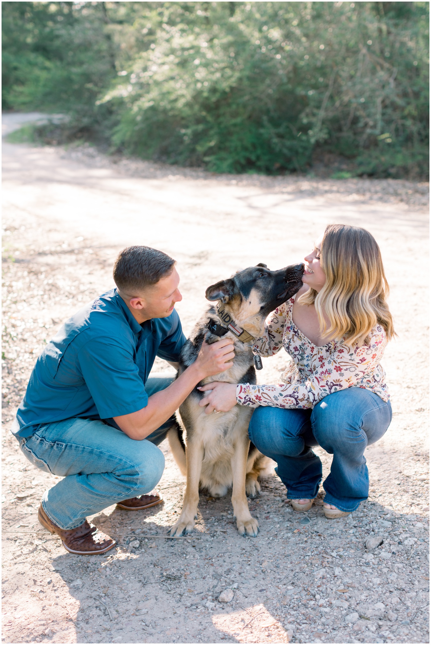 a dog licks the face of his owner in the engagement photos