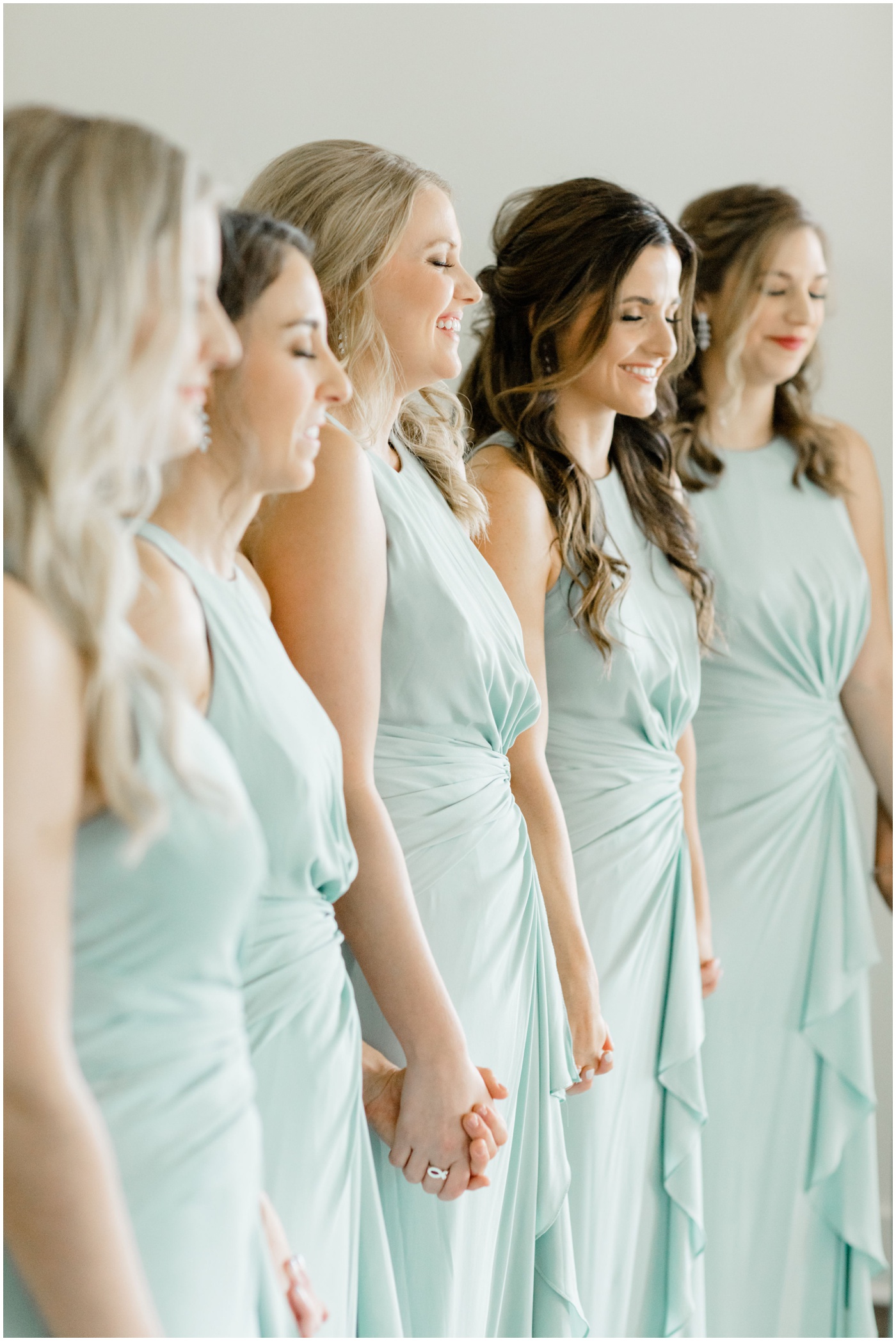 bridesmaids standing with their eyes closed waiting to see the bride