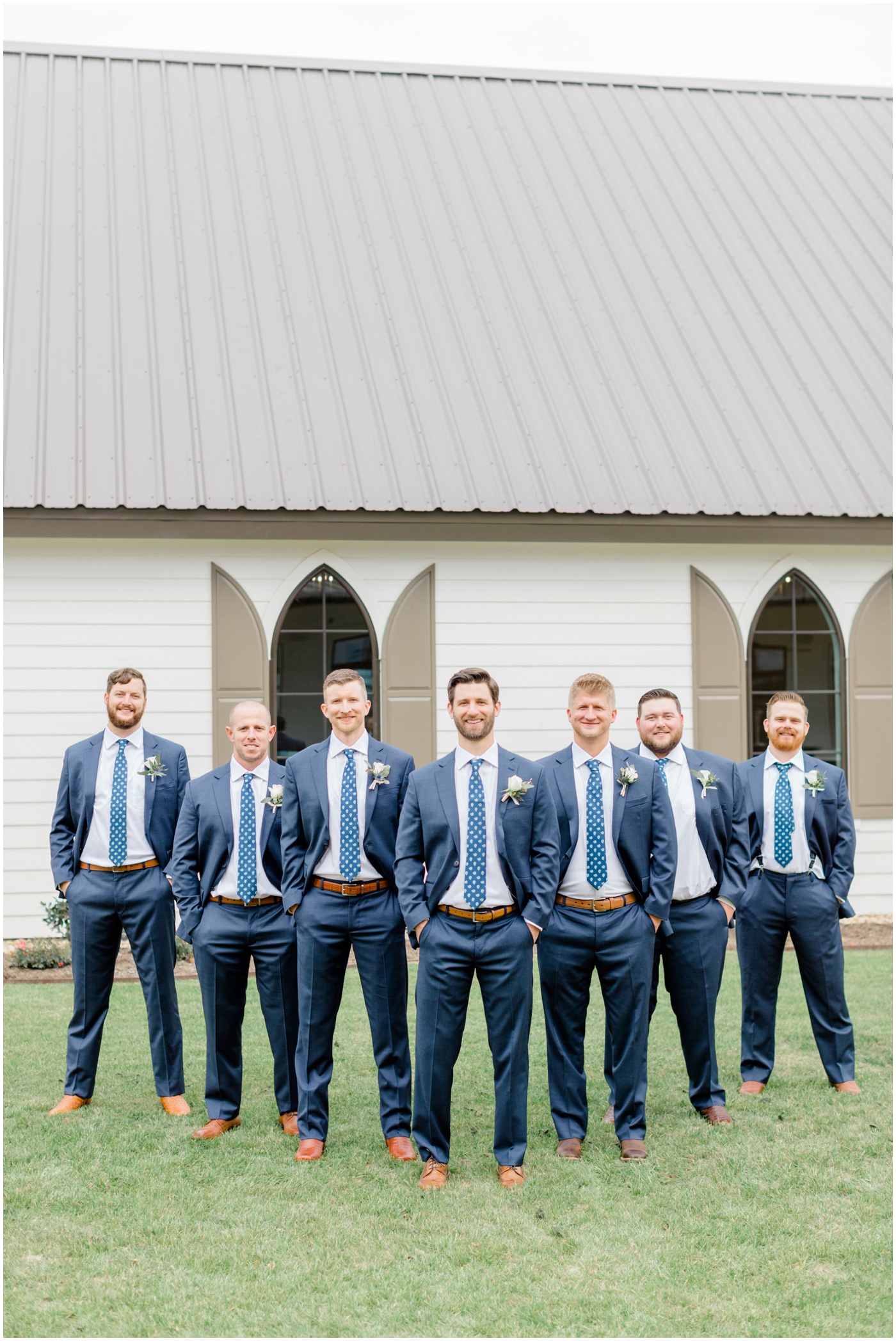 a groom is smiling with his groomsmen