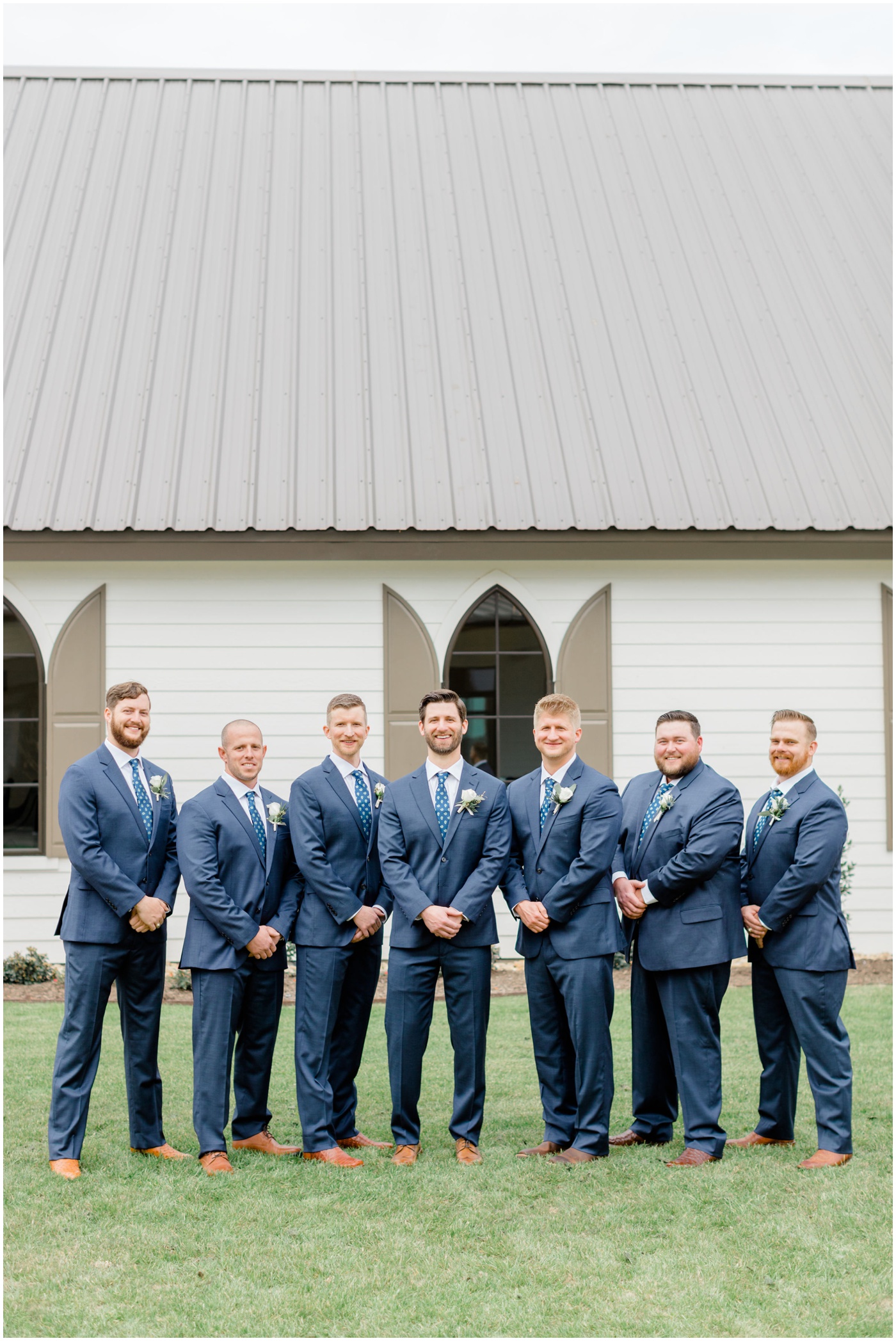 a groom is smiling with his groomsmen at his wedding in Texas