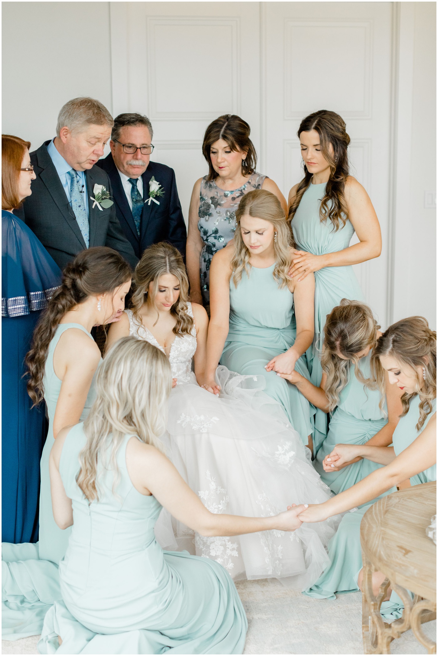 a bride is being prayed over by her friends and family on her wedding day 