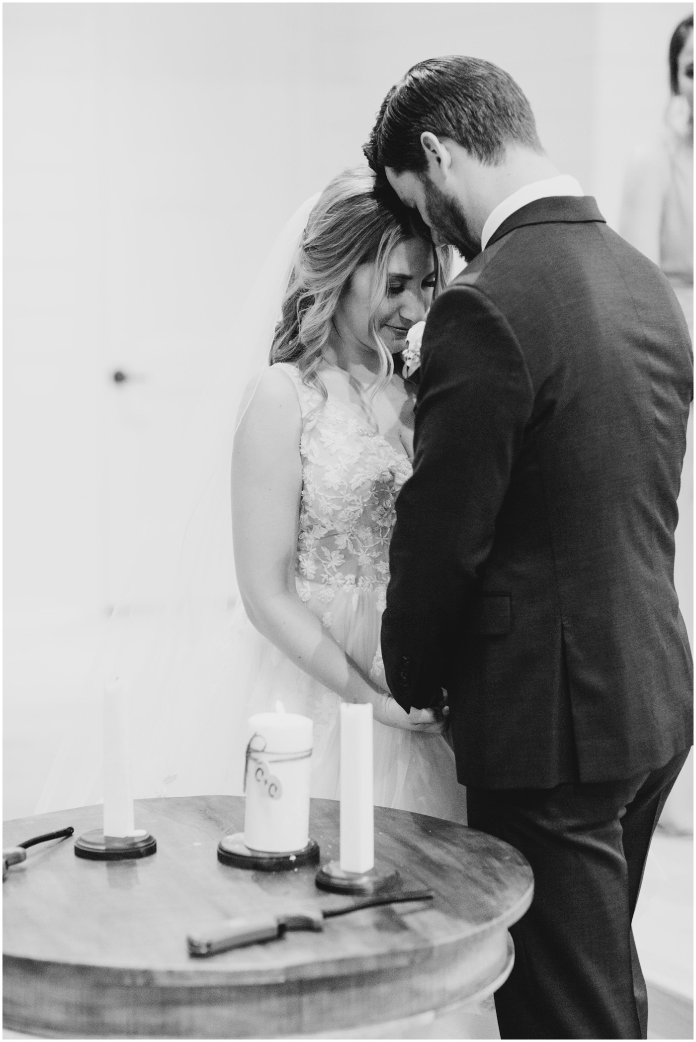 bride and groom praying together during their wedding ceremony in Texas