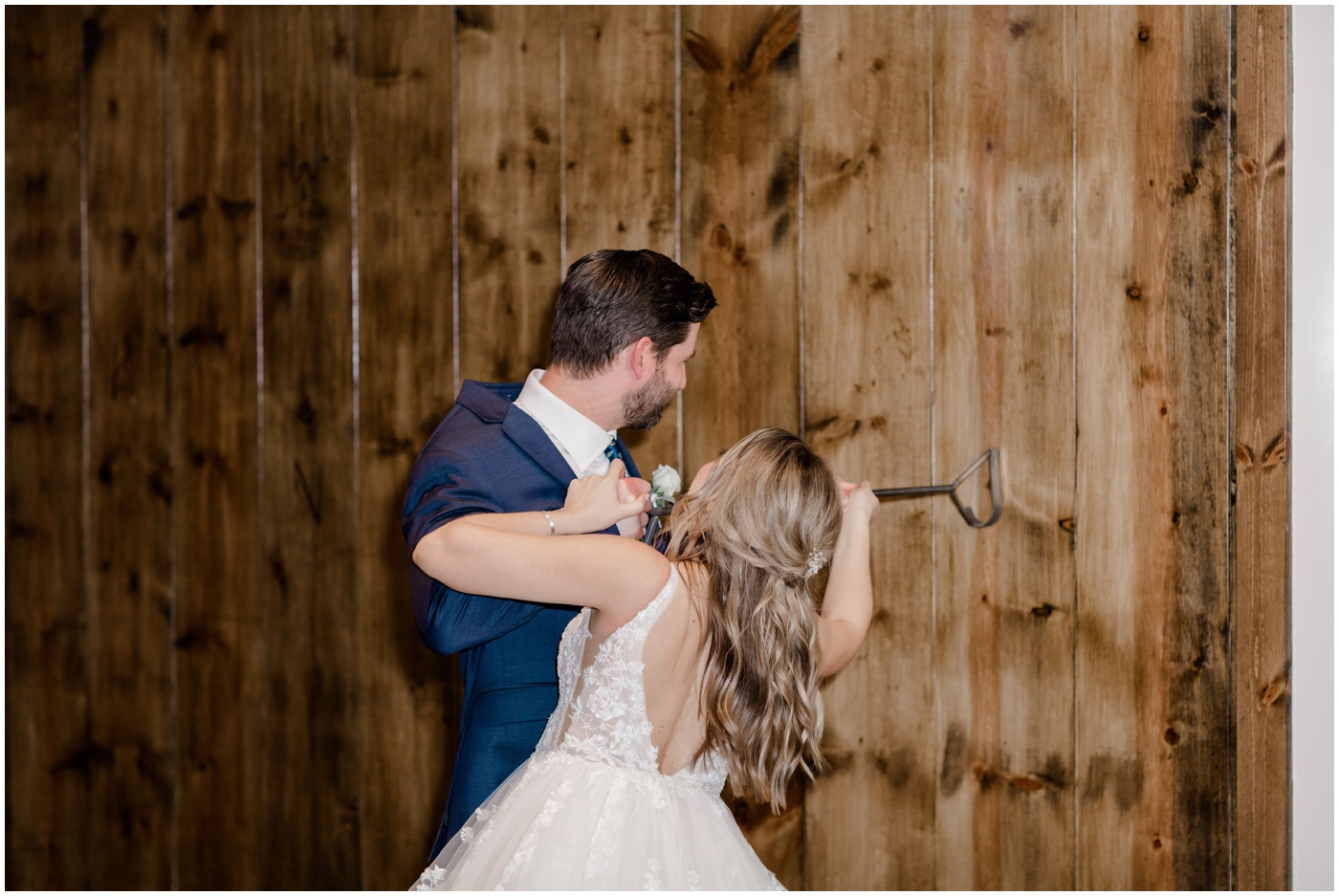 bride and groom brand a wall at their texas wedding venue