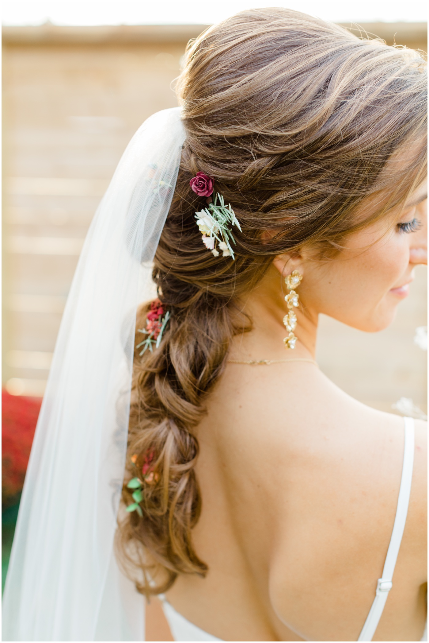 a close up of a bride's braided hair and veil during her bridal portaits