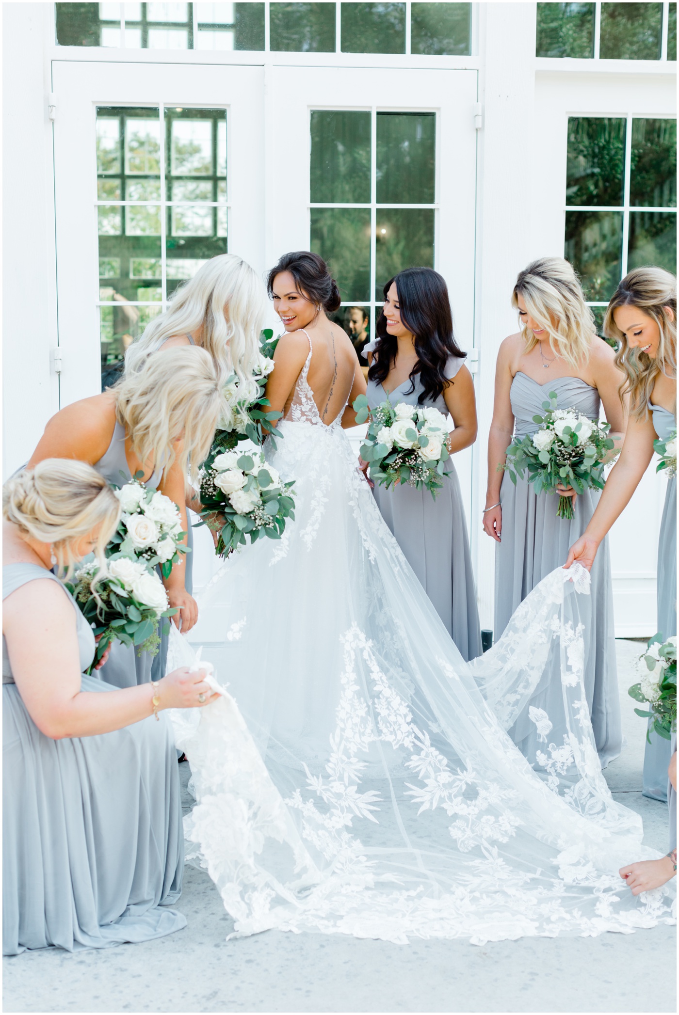 bridesmaids admiring the bride in her wedding dress