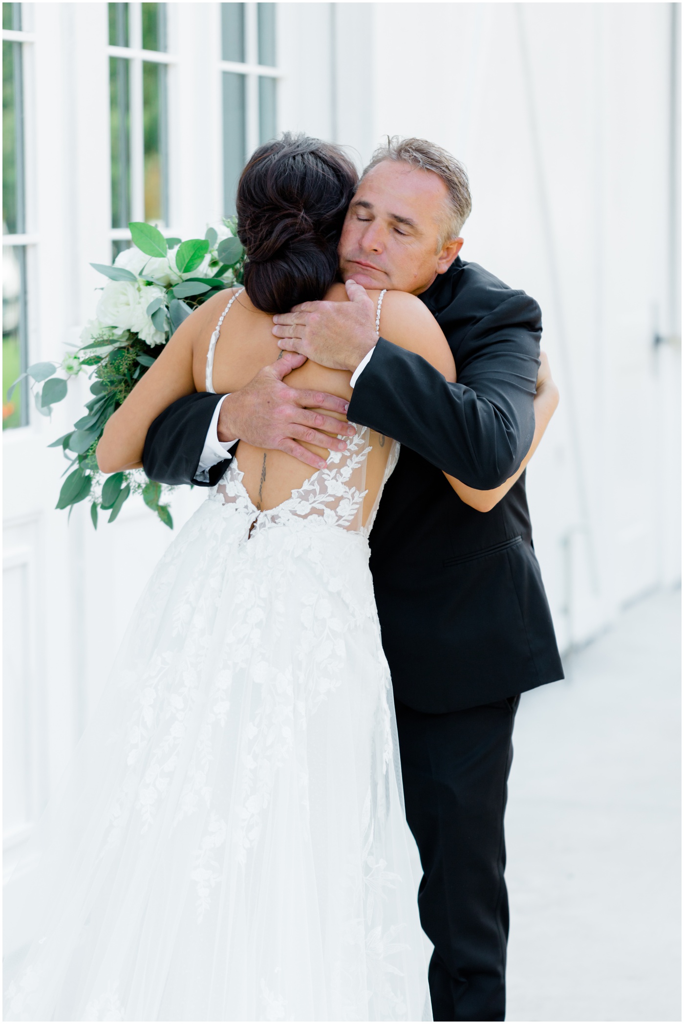 wedding photographer in Houston captures a bride and her father hugging 