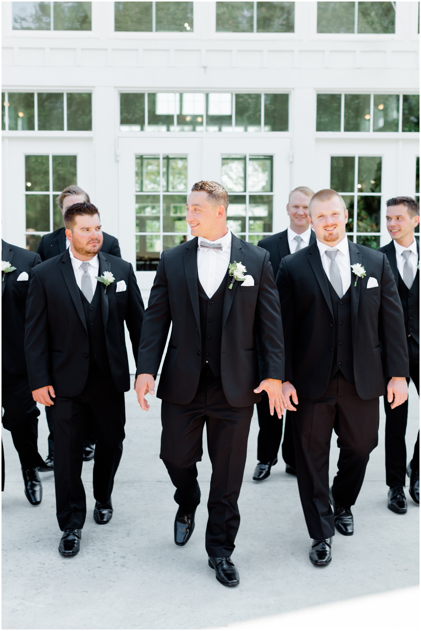 a groom laughing with his groomsmen 