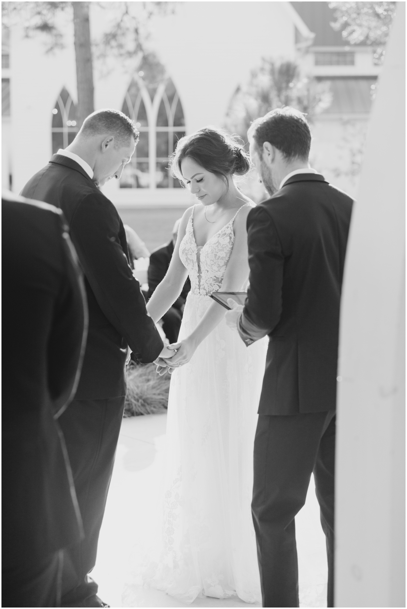 a bride and groom praying together during their wedding ceremony