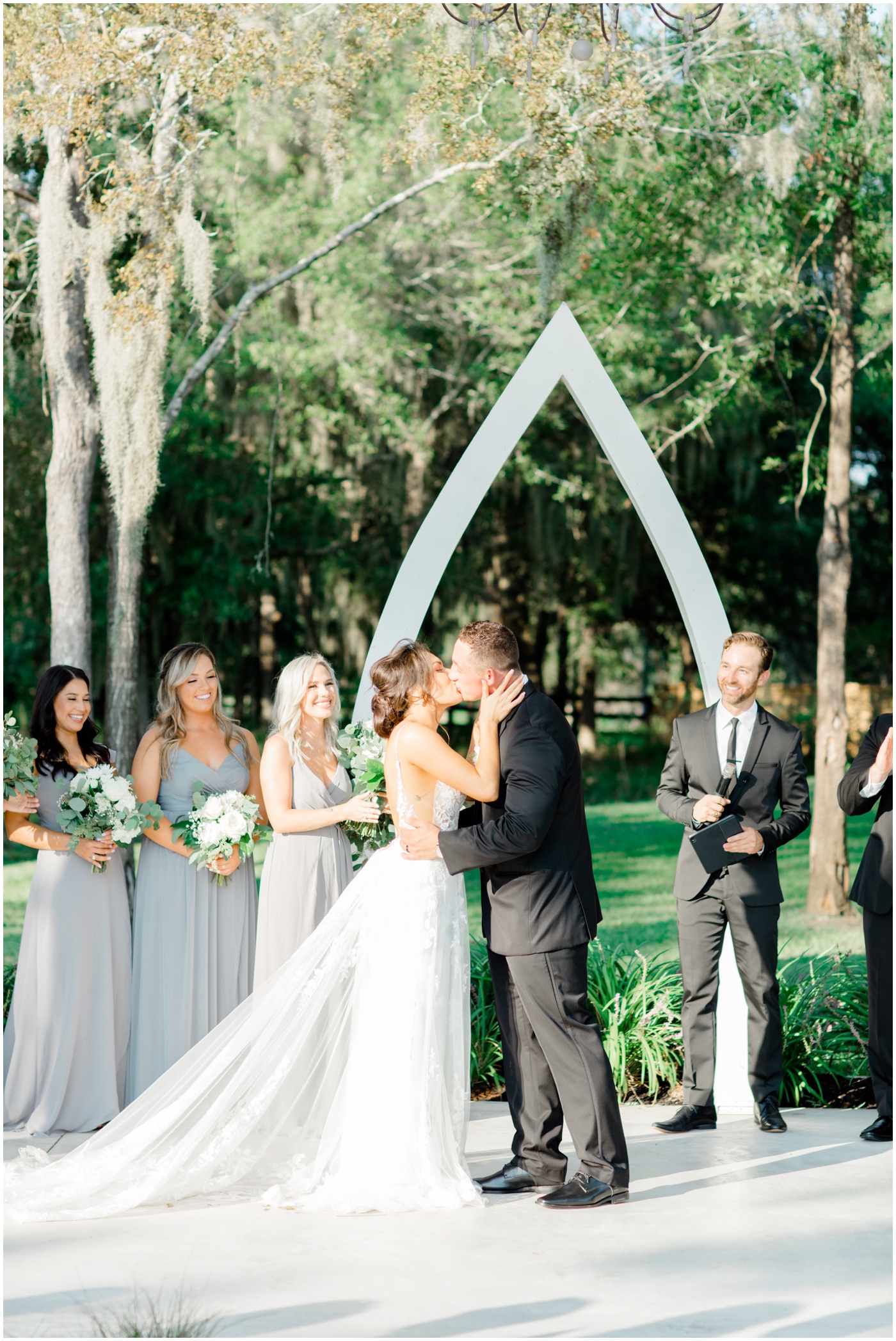 bride and groom share their first kiss