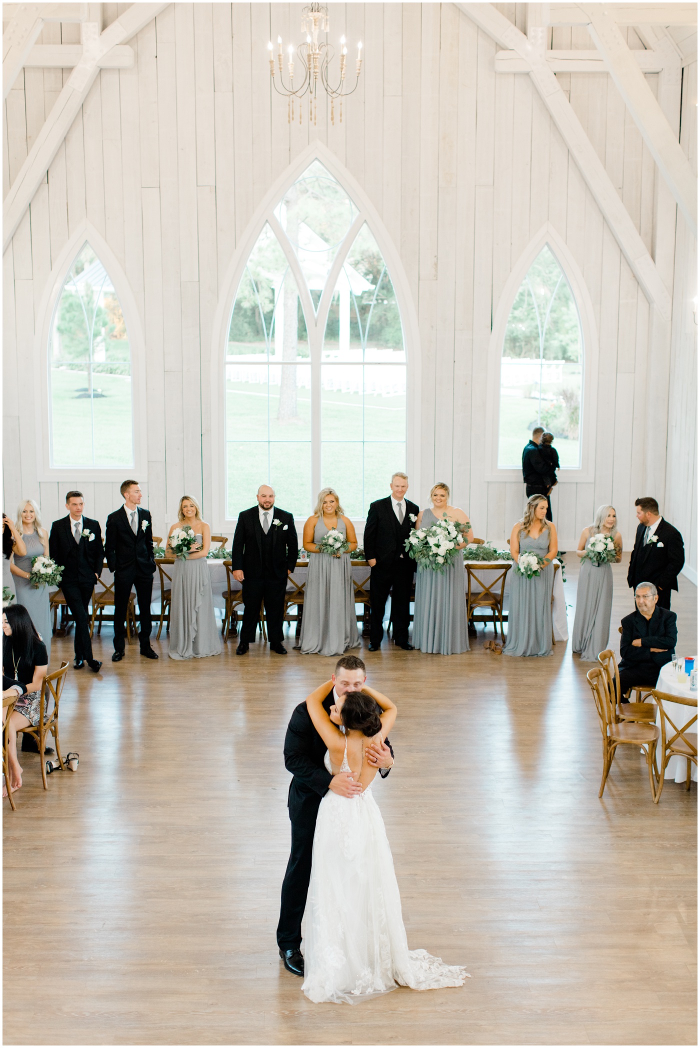 wedding party smiles during bride and groom first dance