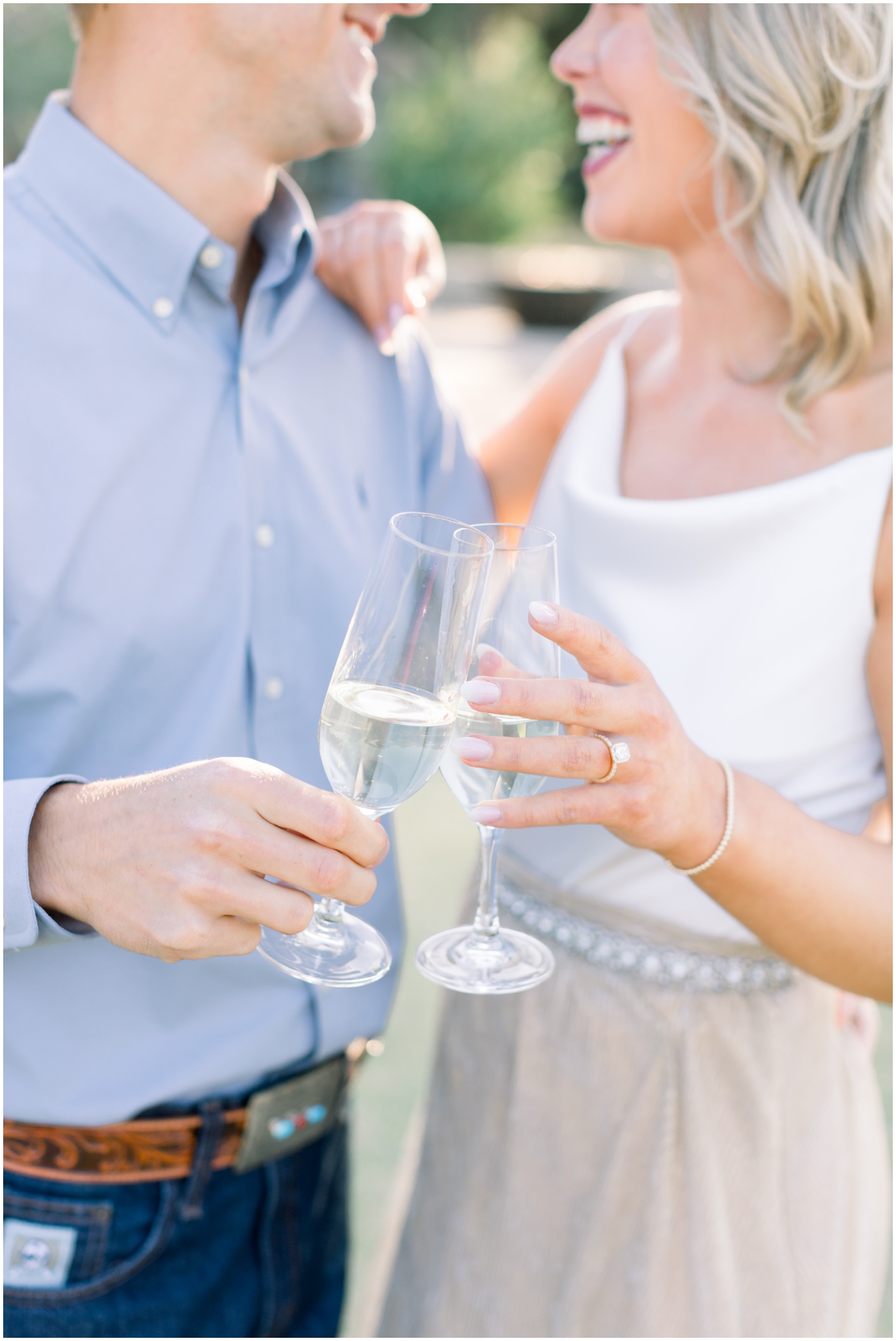 a couple toast with champagne at their houston engagement session