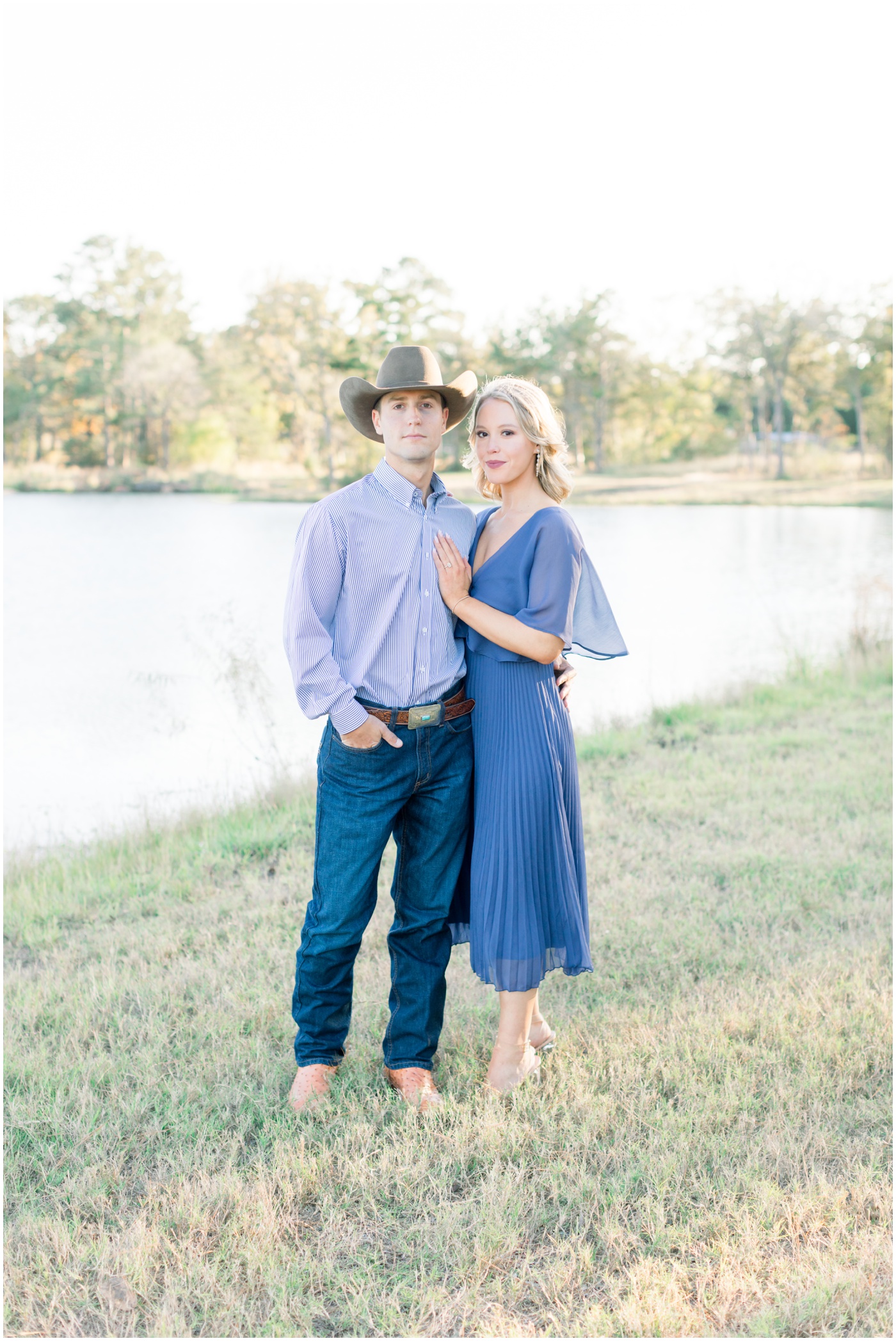a couple smile by the pond at sunset during their engagement session in Texas 