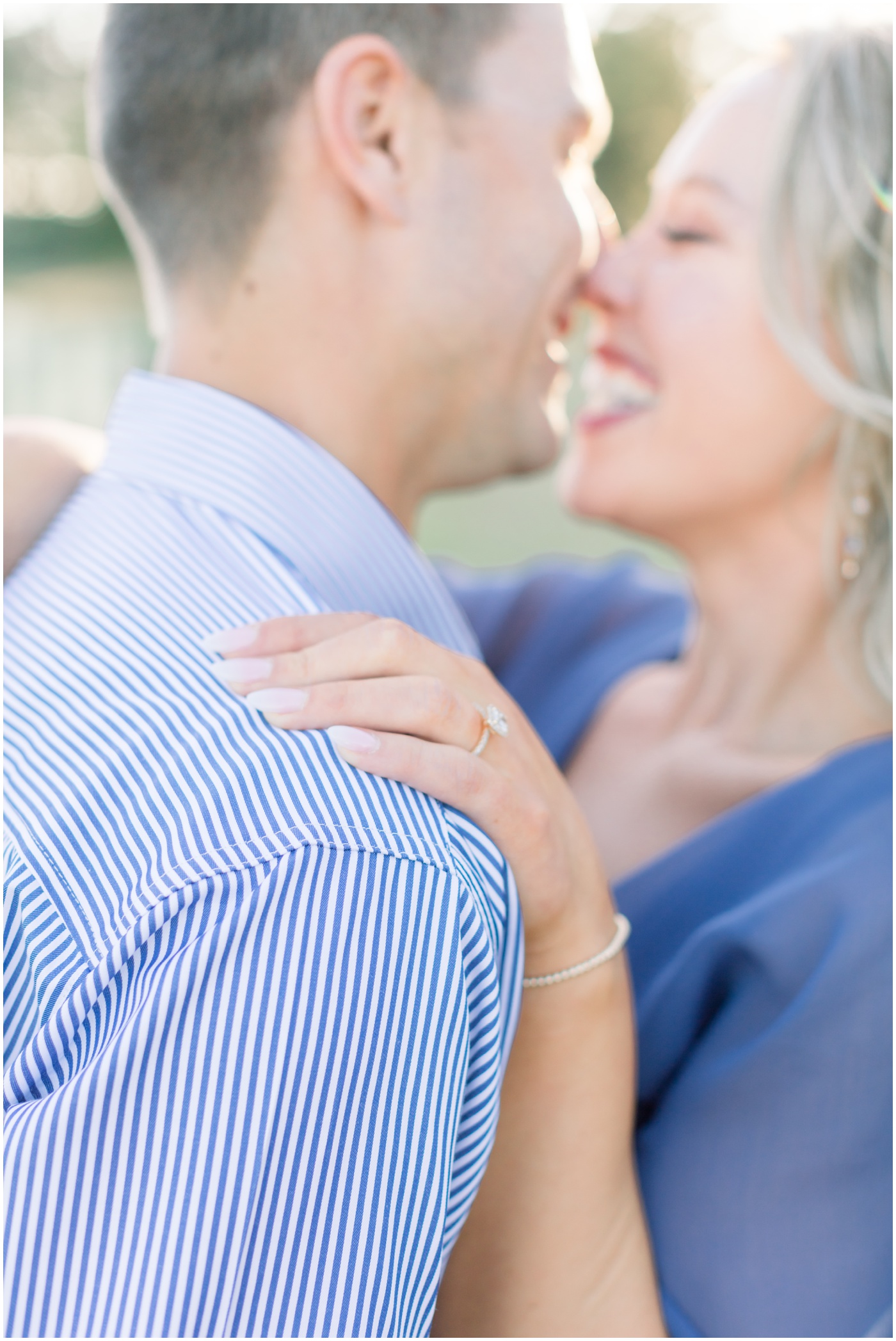 a close up of a couple laughing as they kiss during their houston engagement session