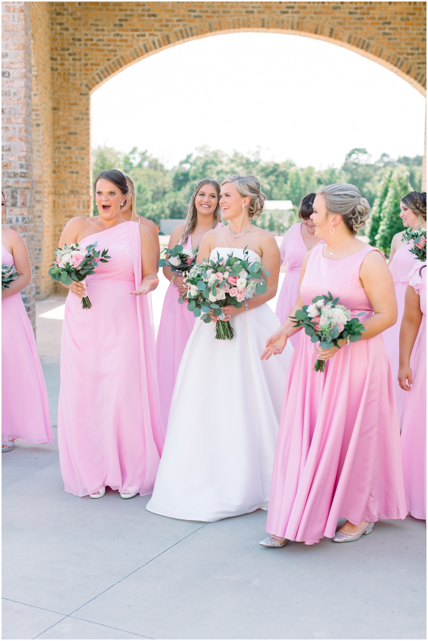 bride laughing with her bridesmaids