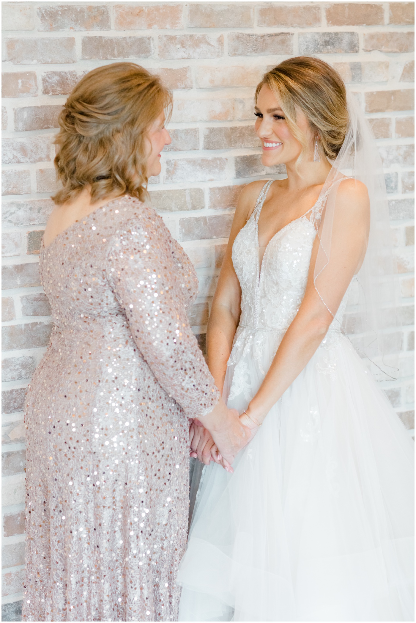 bride and mom smiling at each other
