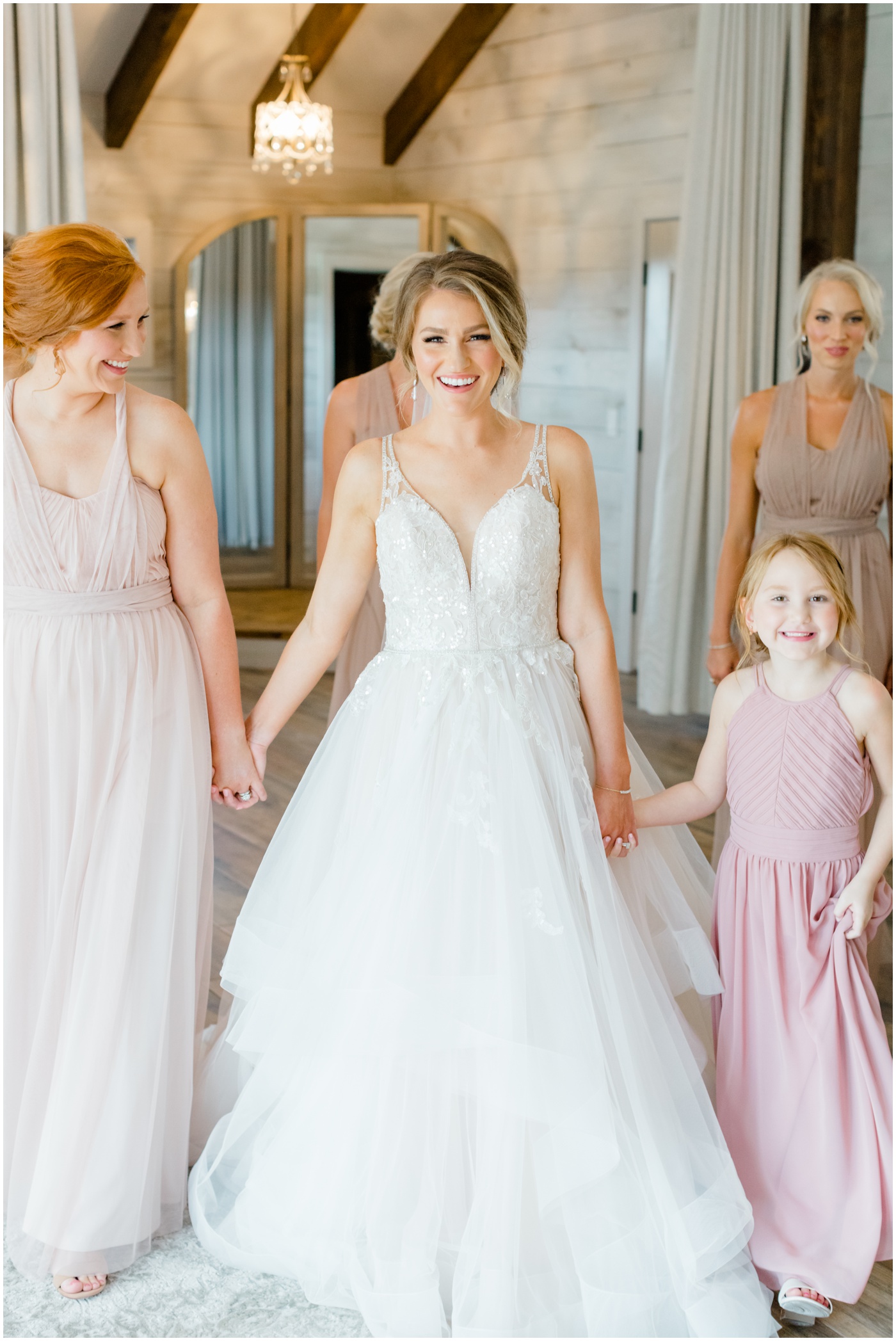 a bride smiling with her bridesmaids