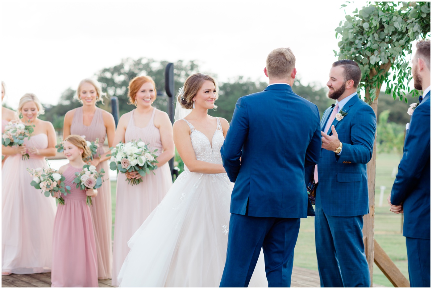 bride smiling at groom during the college station wedding ceremony