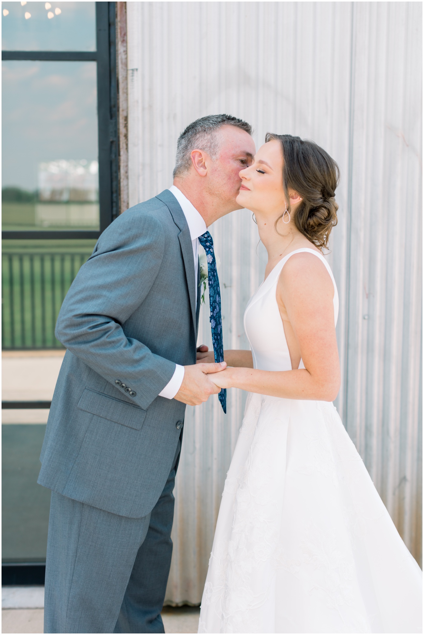 bride's dad kisses bride's cheek