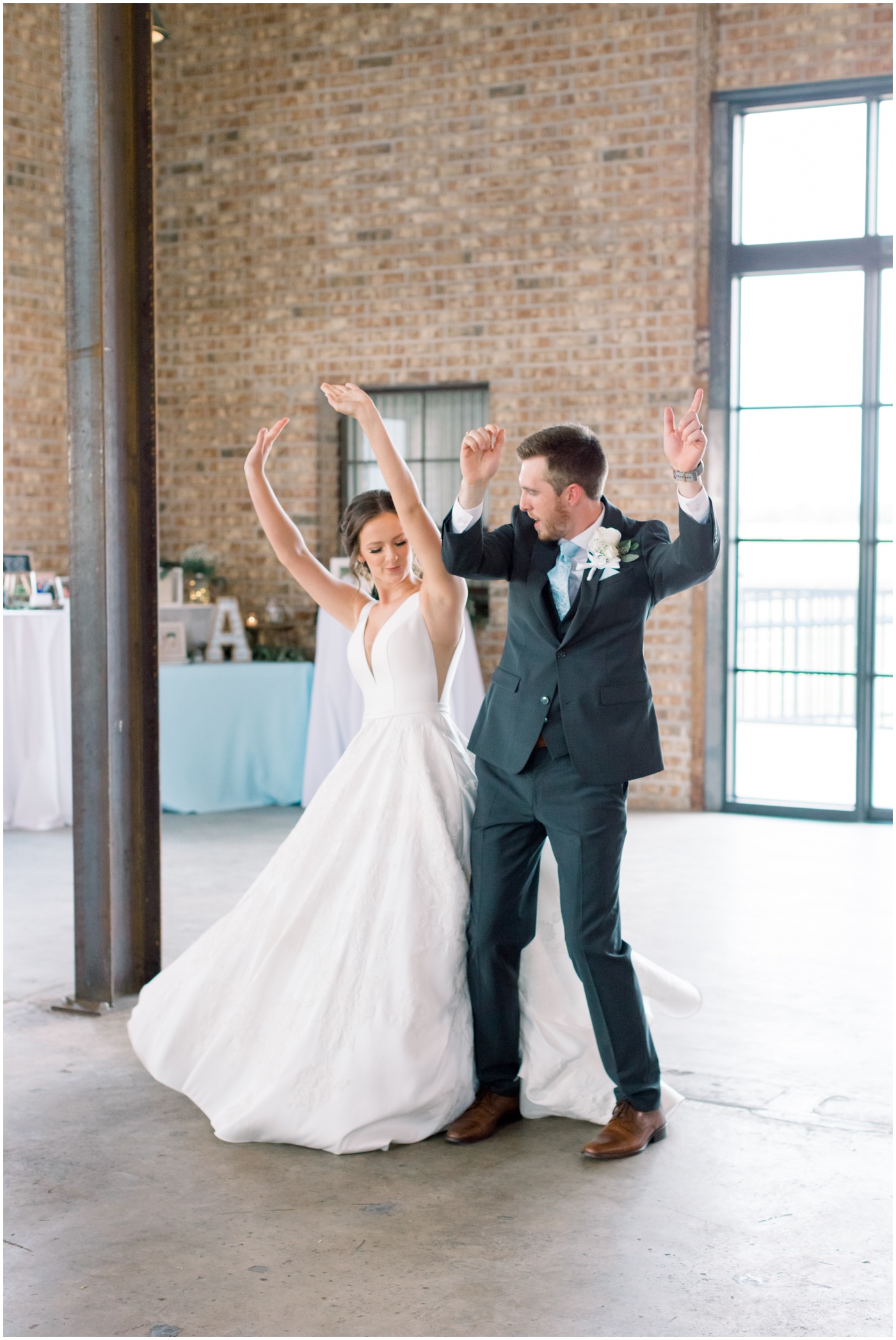 bride and groom bump hips during grand entrance