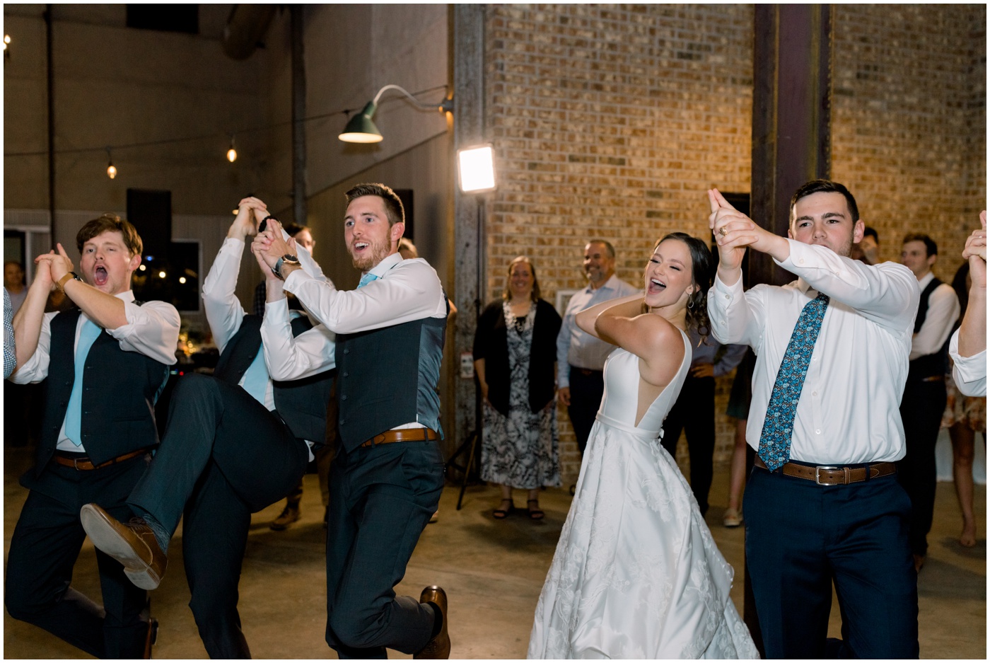 guests singing the aggie war hymn at this Texas wedding