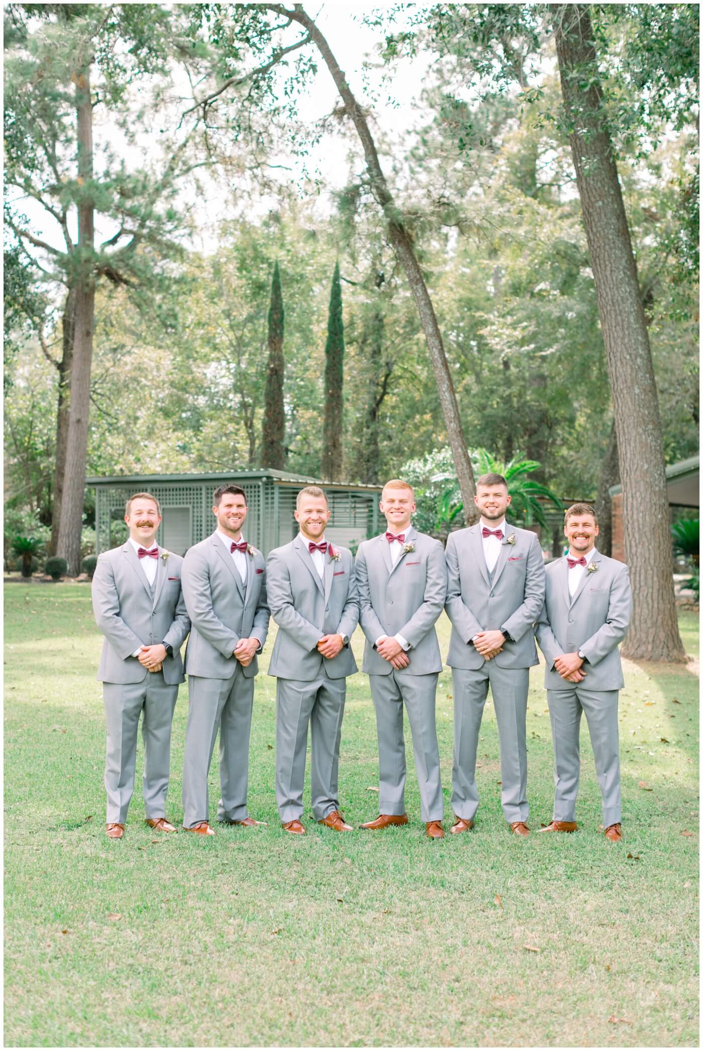 a groom smiles with his groomsmen