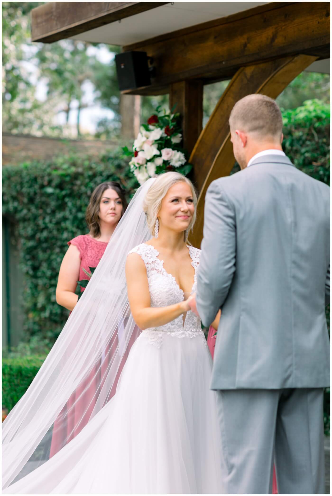 the bride smiles at her groom during the wedding ceremony in houston