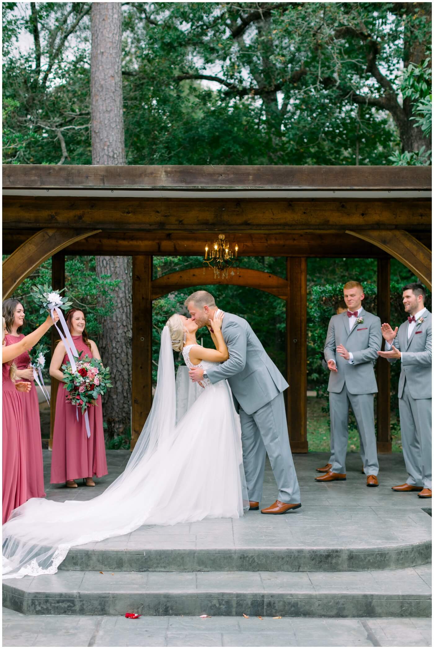 the bride and groom share their first kiss at their texas wedding