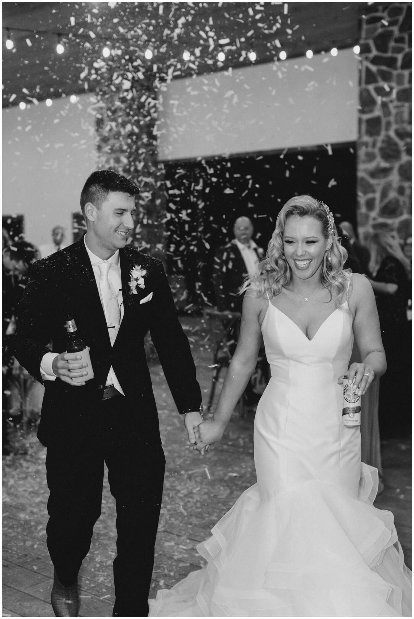 Houston Wedding at The Vine | confetti falls as the bride and groom enter their reception