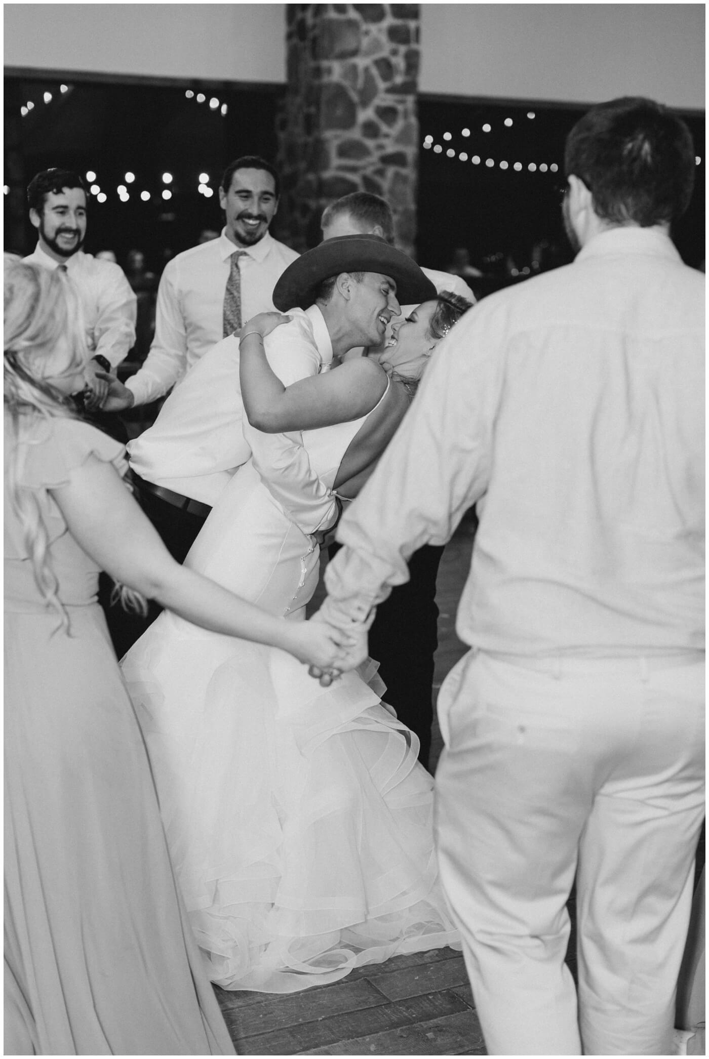 Houston Wedding at The Vine | the bride and groom laugh together while dancing with their wedding guests
