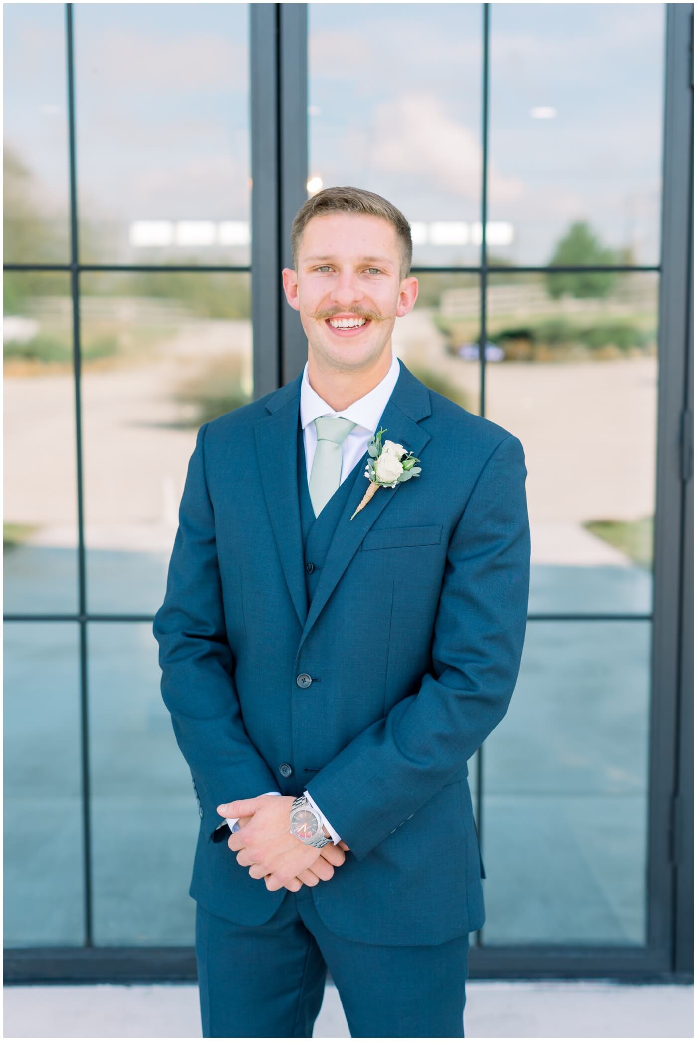 Texas farmhouse wedding | the groom smiles on his wedding day 