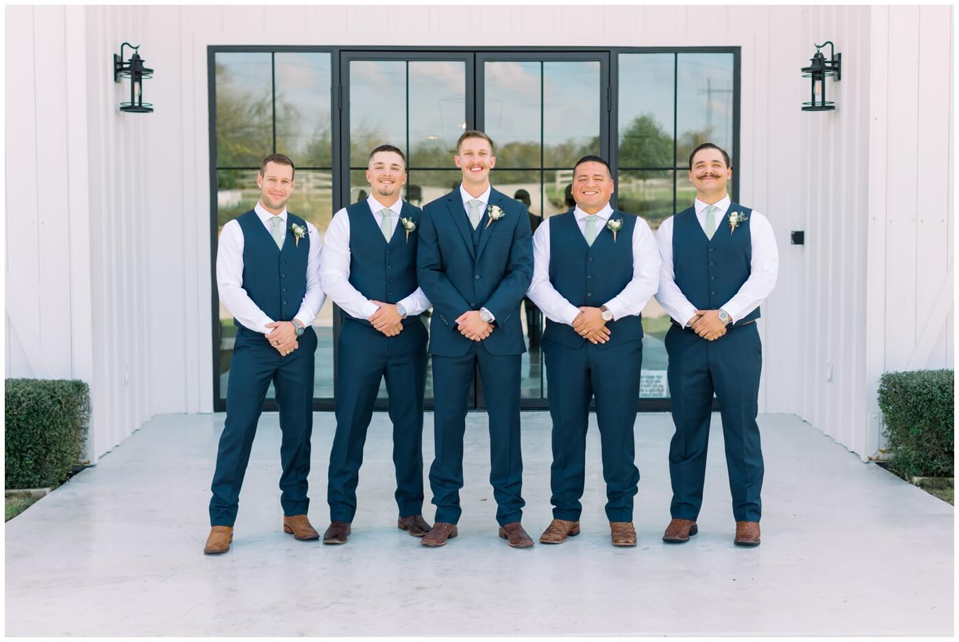 Texas farmhouse wedding | the groom smiles with his groomsmen