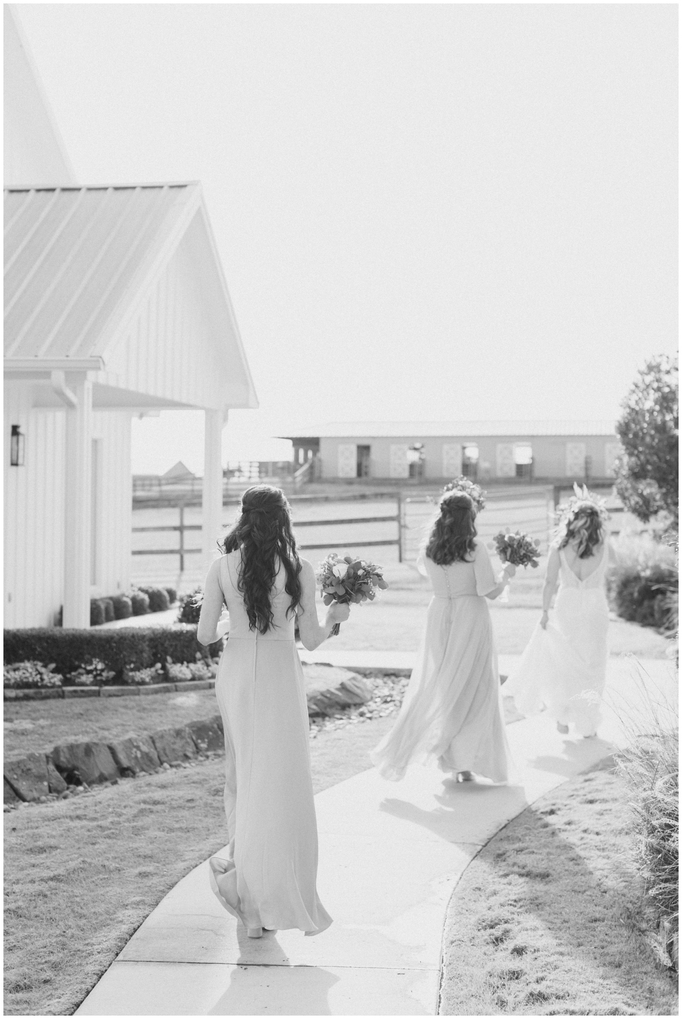 the bridesmaids and bride walk toward the chapel as they prepare for the ceremony to begin