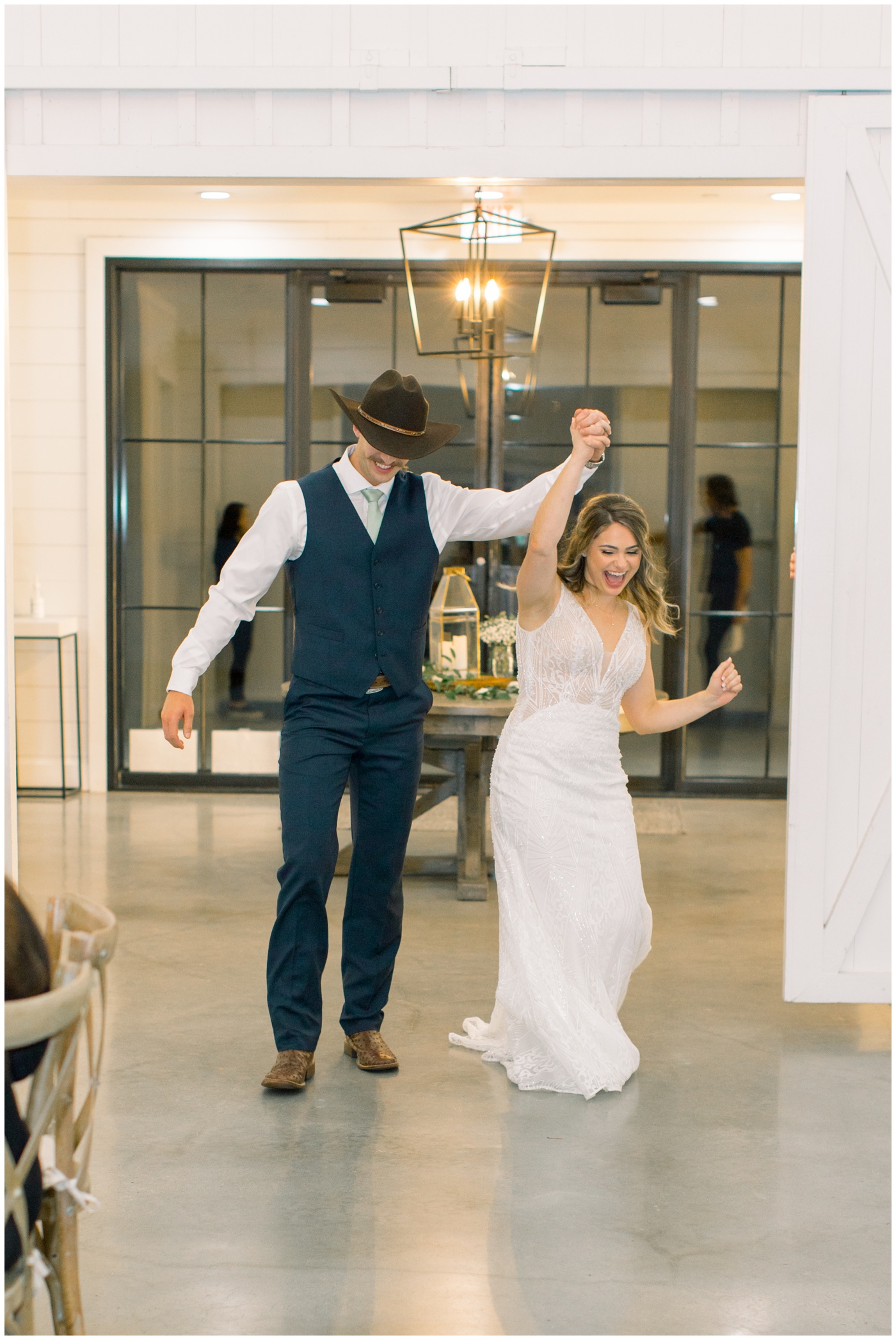 Texas farmhouse wedding | the bride and groom celebrate during the grand entrance 