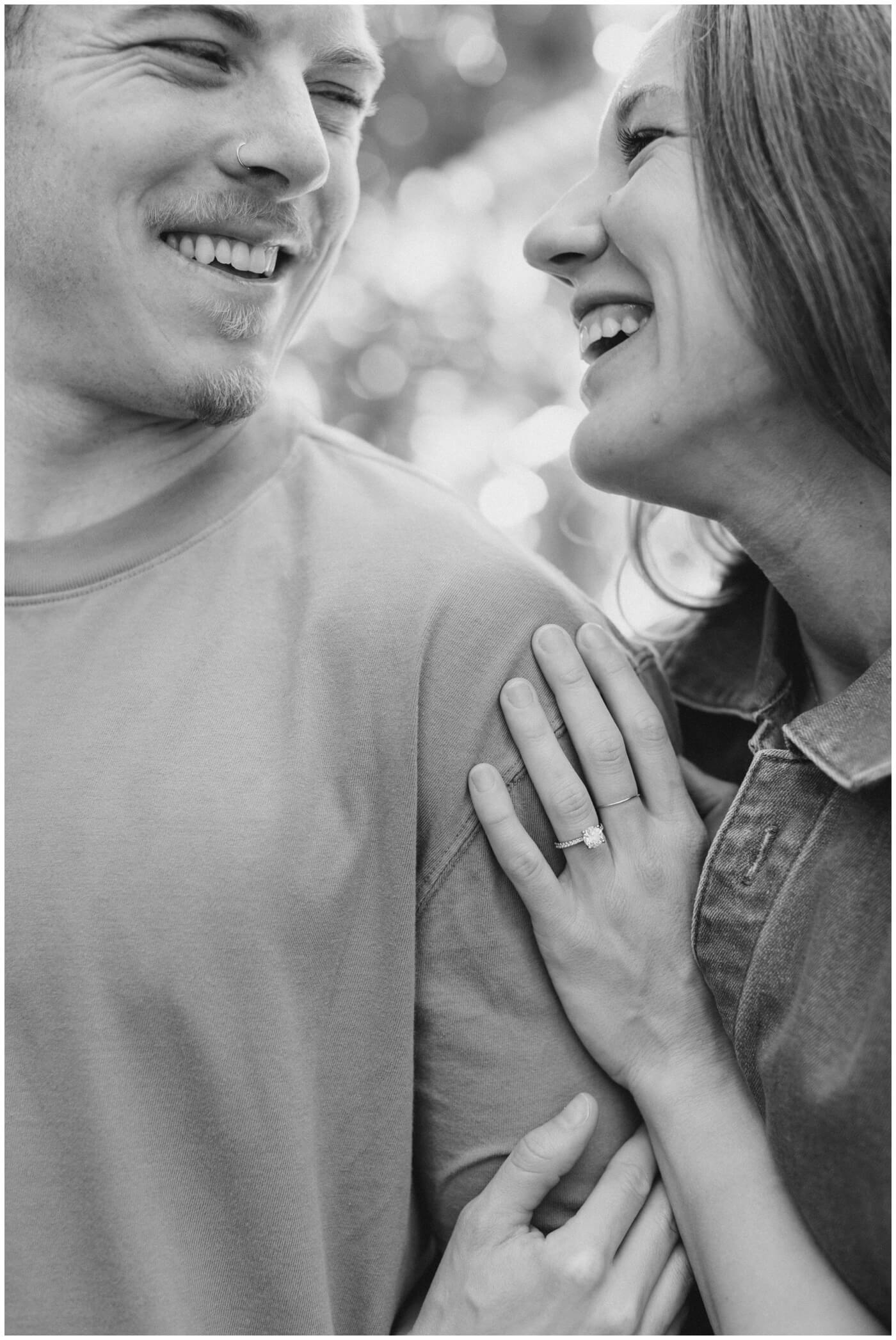 destination wedding photographer | a couple laughs together during their engagement session.