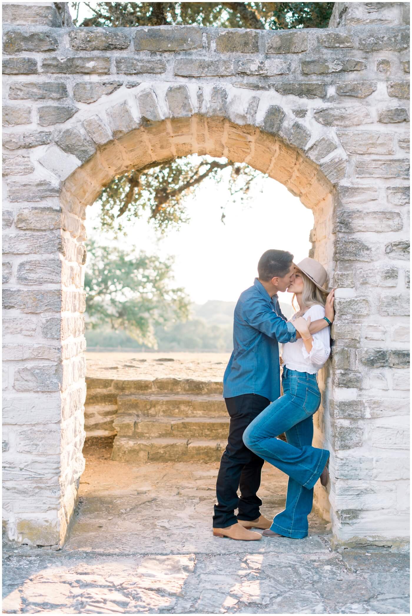 A couple kisses during their engagement photos in Houston. 