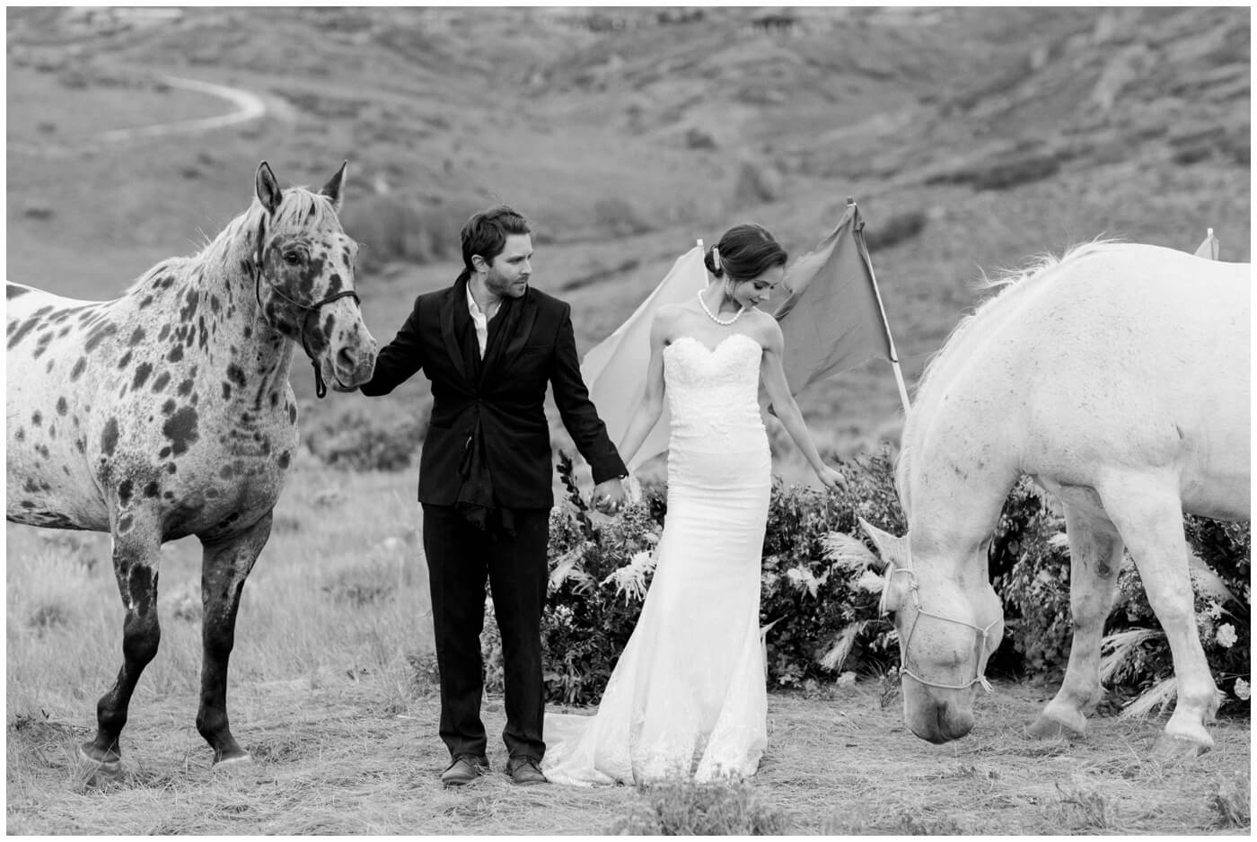 Wedding in the mountains | A couple stand next to their horses on their wedding day