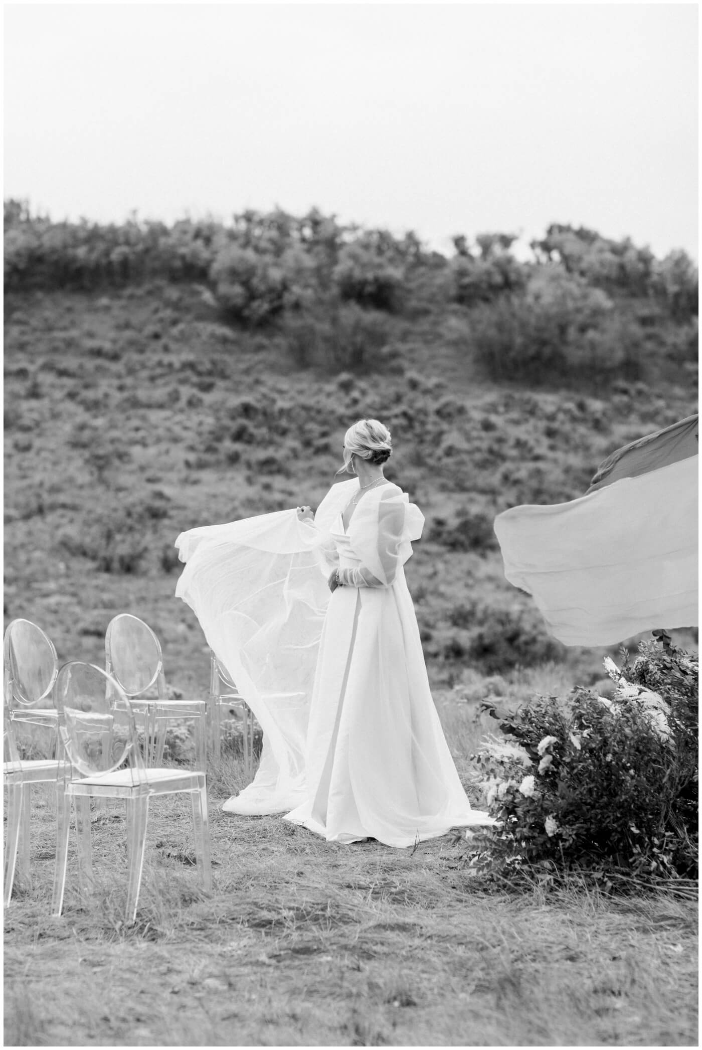 Wedding in the mountains | A bride's dress blows in the wind in the Utah mountains