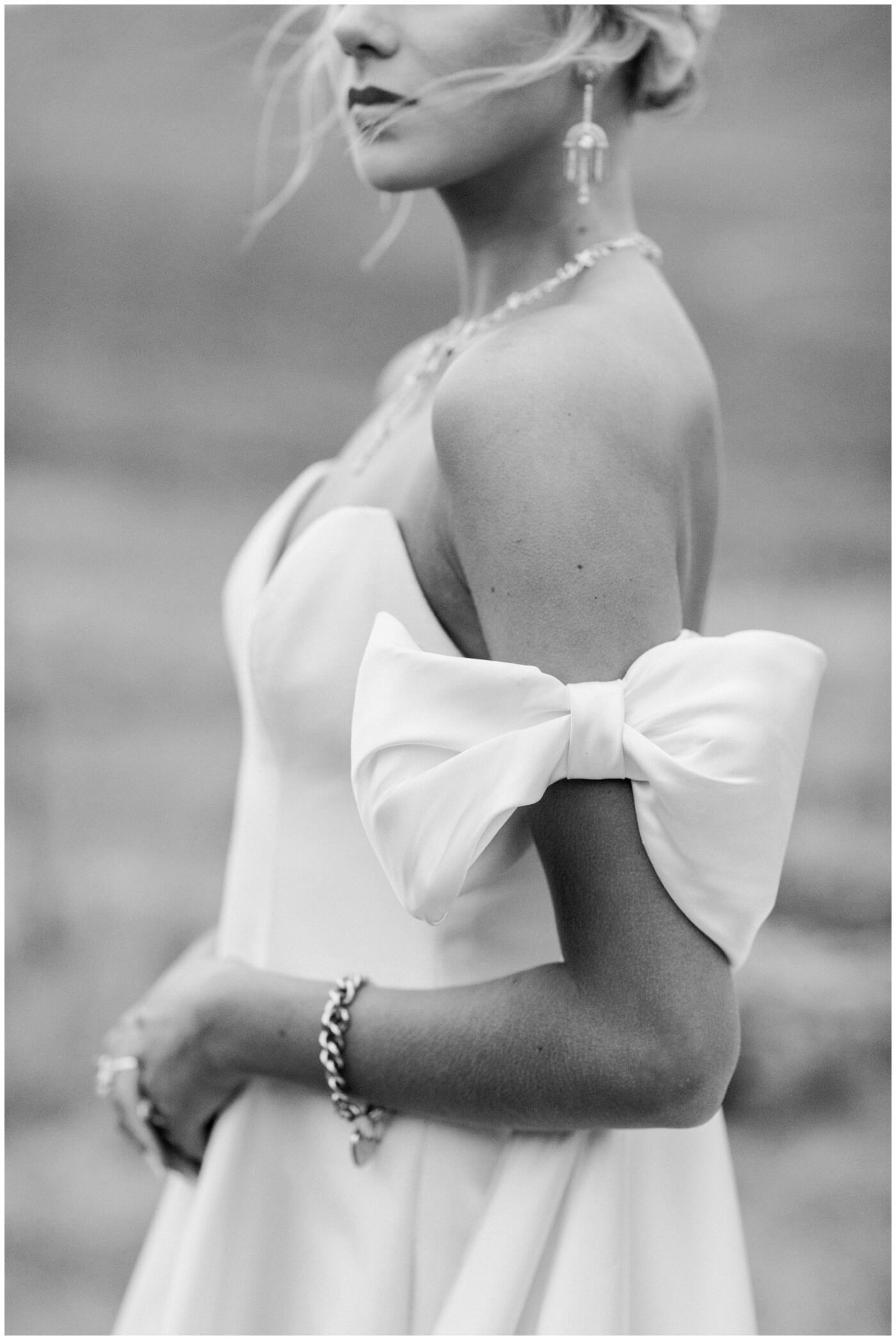 Wedding in the mountains | A bride stuns in her elegant wedding dress with bow details