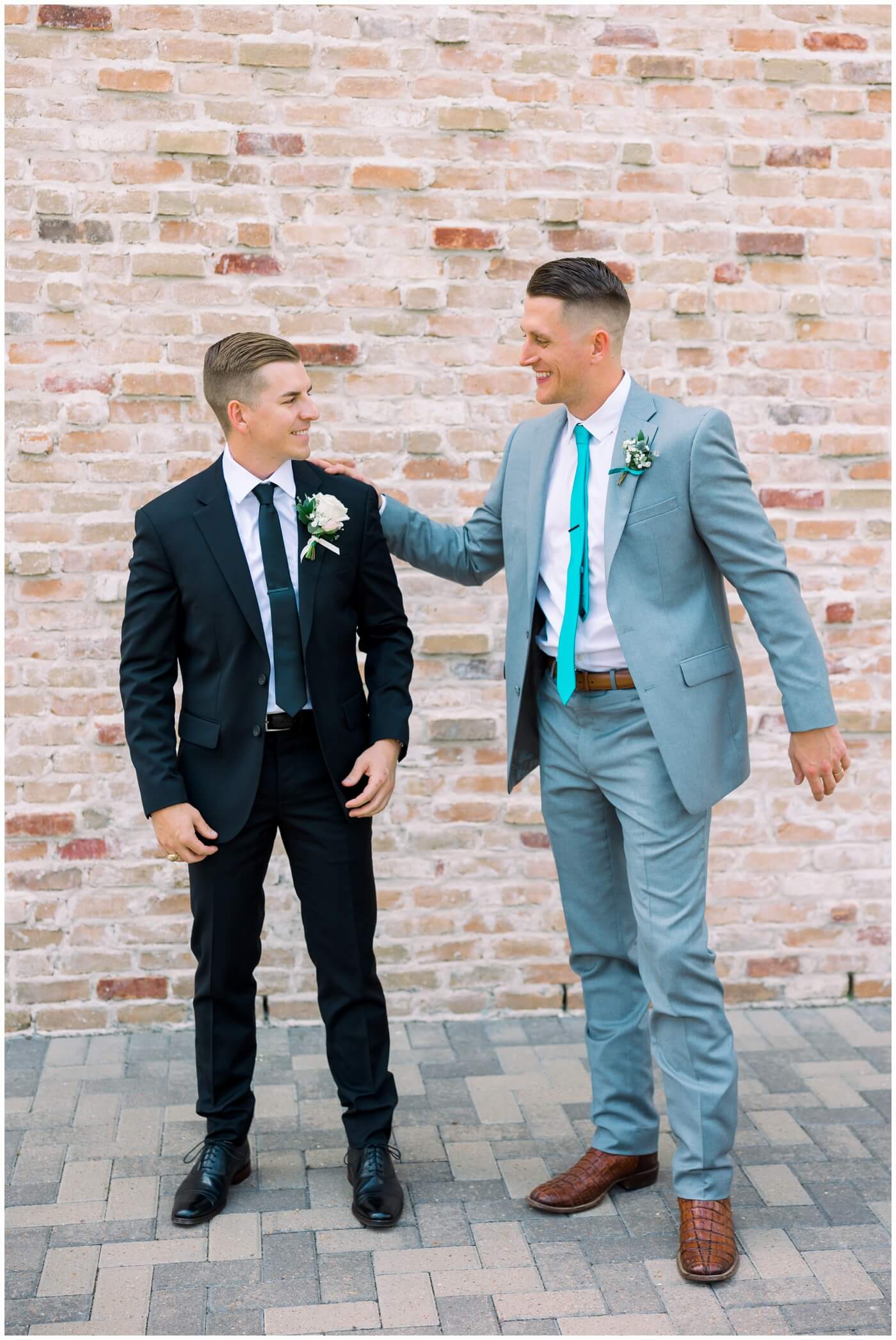 A groom's brother smiles as his brother prepares for his wedding day 