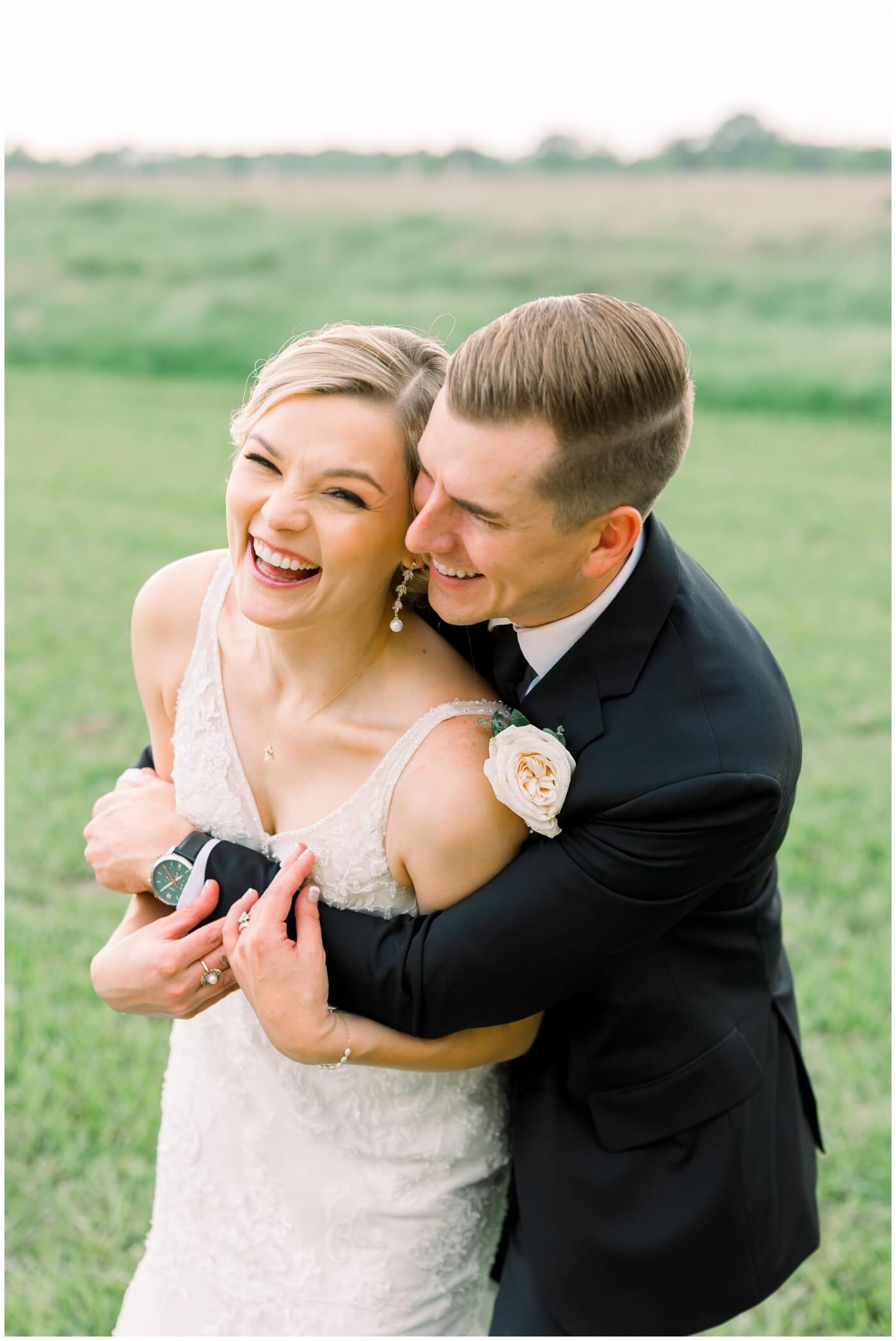 The couple laughs joyfully on their wedding day