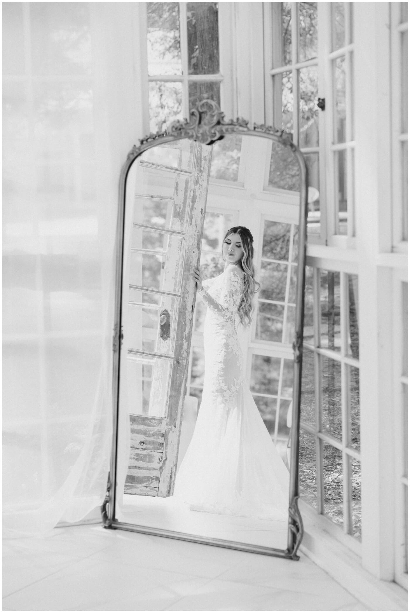 Wedding photographer in Houston | A bride smiles down her shoulder in her wedding dress 