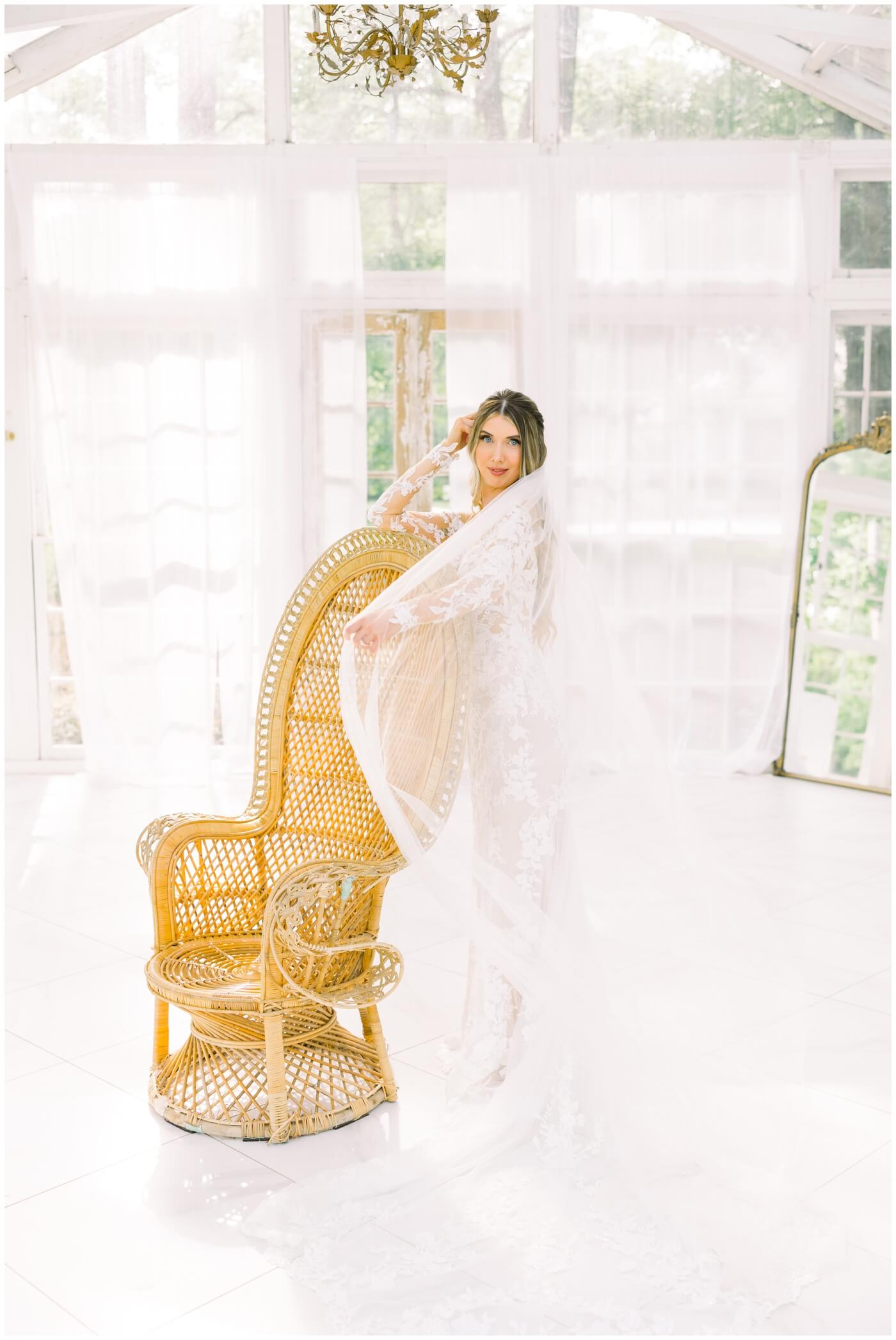Houston wedding photographer | A bride shows off her veil during her bridal session