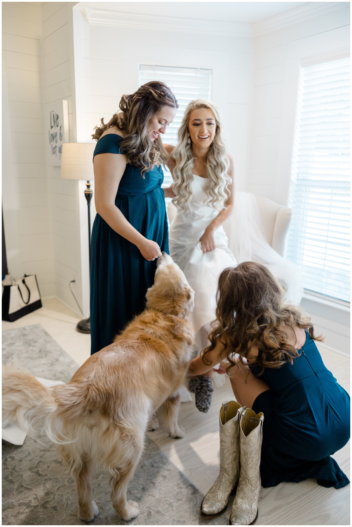 Houston Wedding Photographer | a bride puts her wedding boots on with the help of her sister and matron of honor