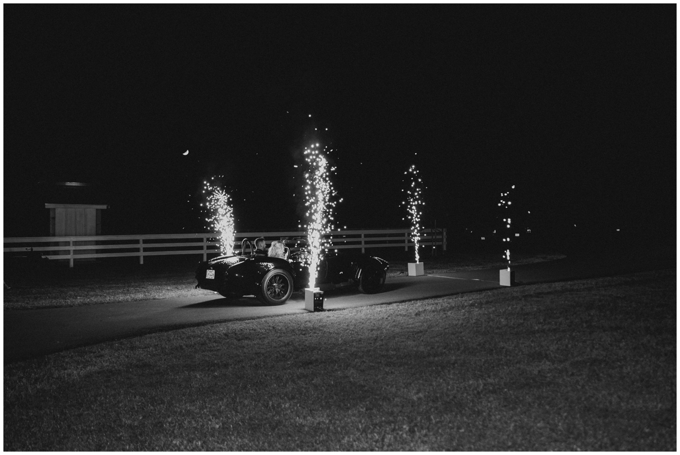 Houston Wedding Photographer | The bride and groom drive away during a sparkler exit