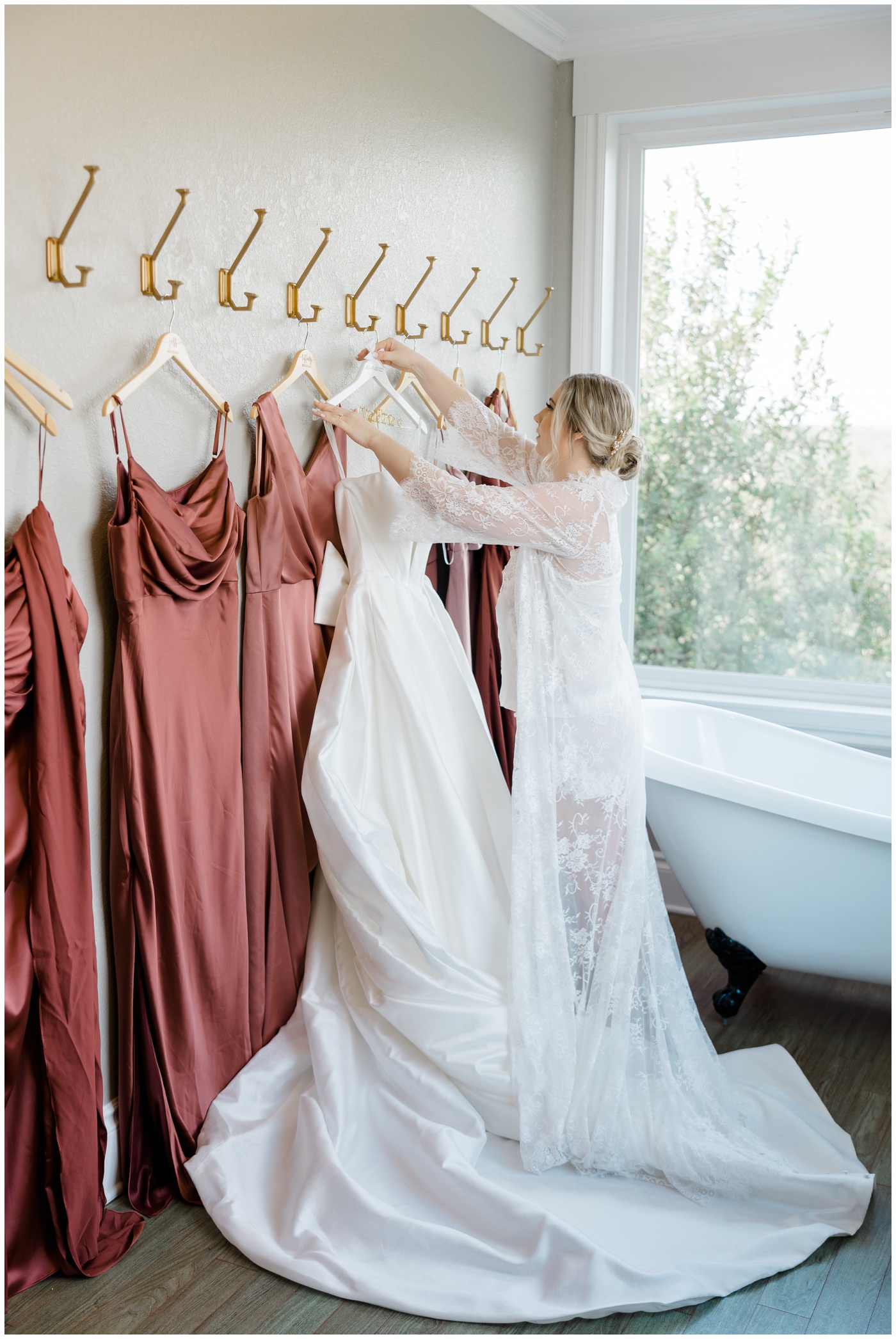A bride hangs up her wedding dress at Kendall Point wedding venue