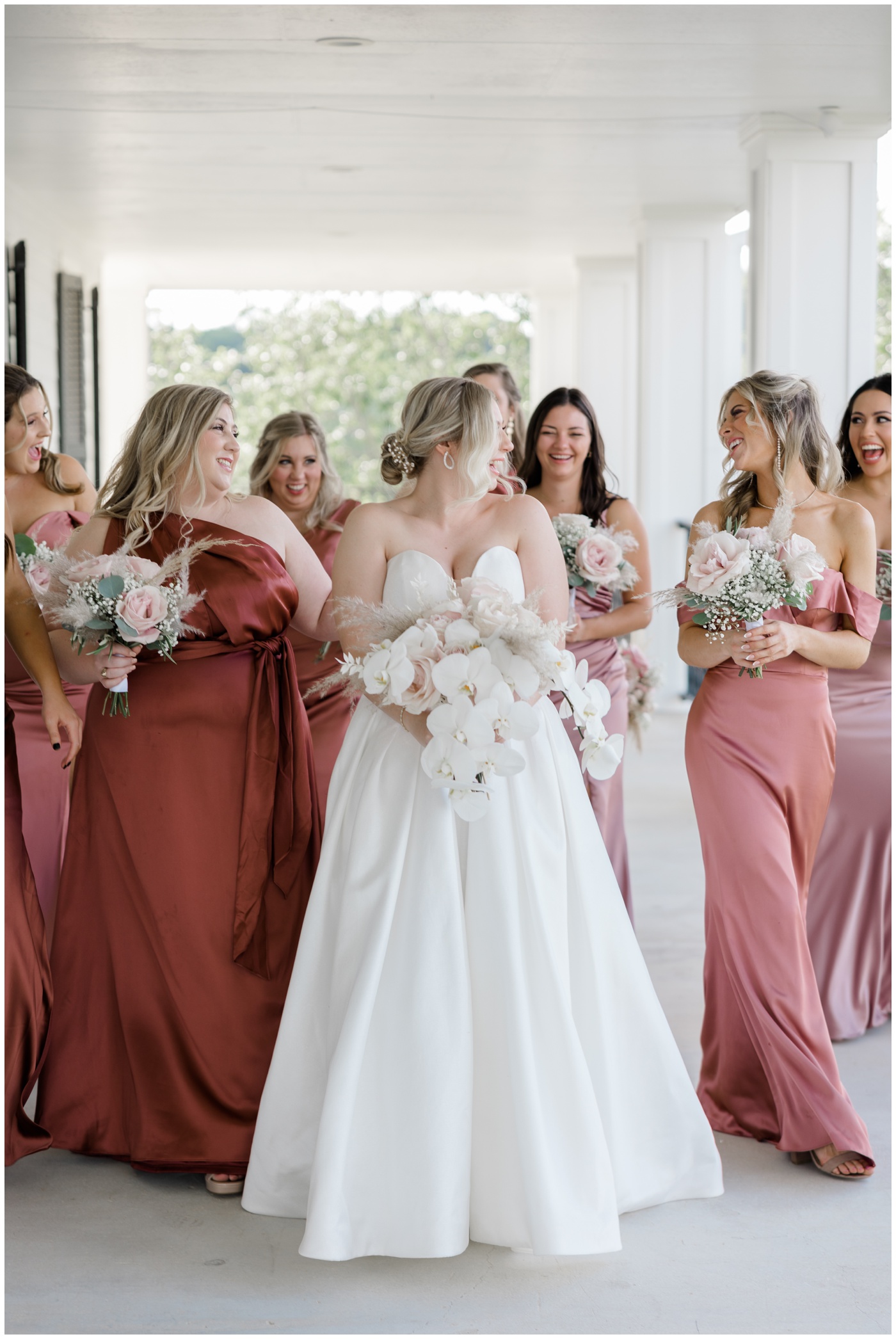 The bridesmaids cheer as they see the bride