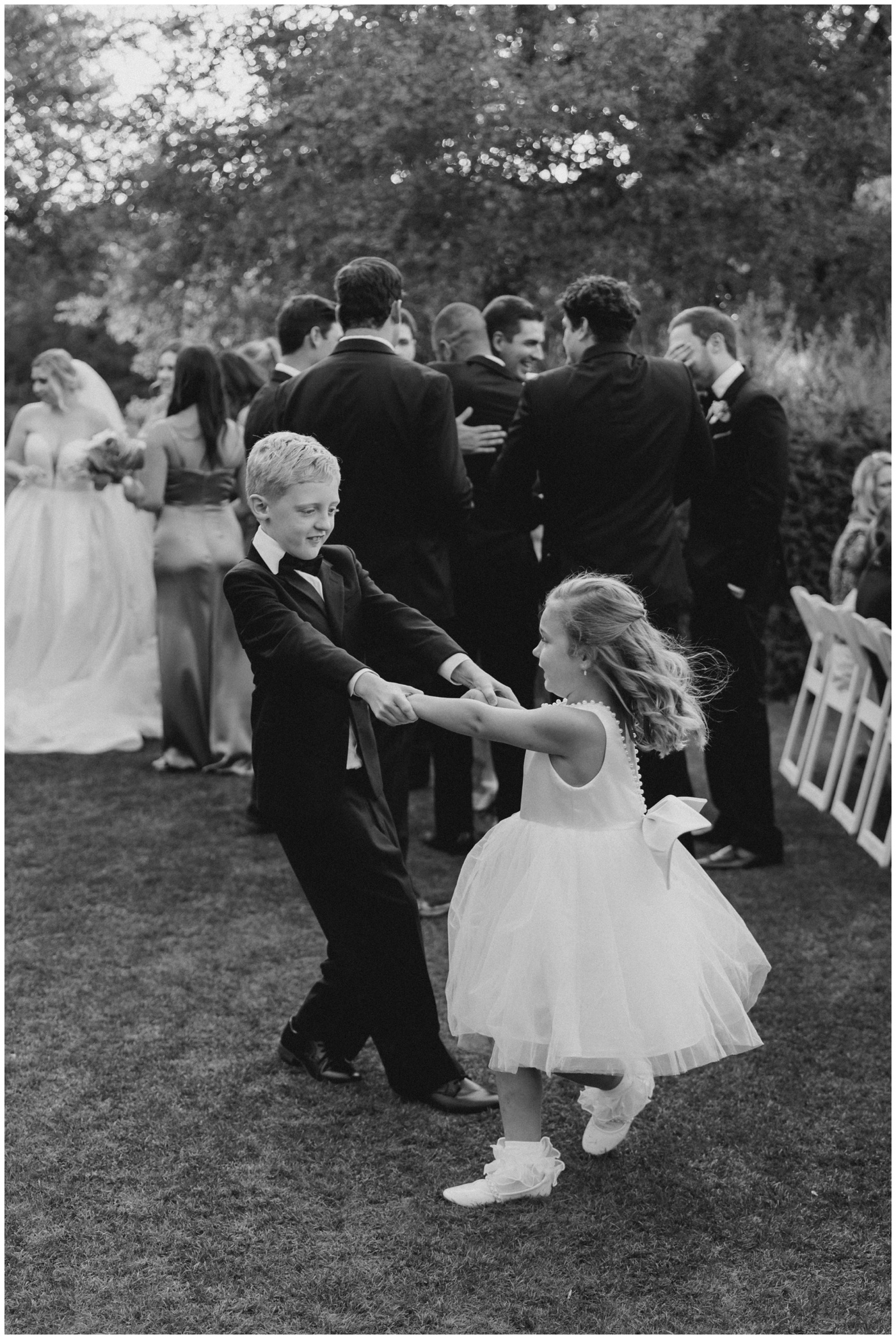 The flower girl and ring bearer dance together after the wedding ceremony