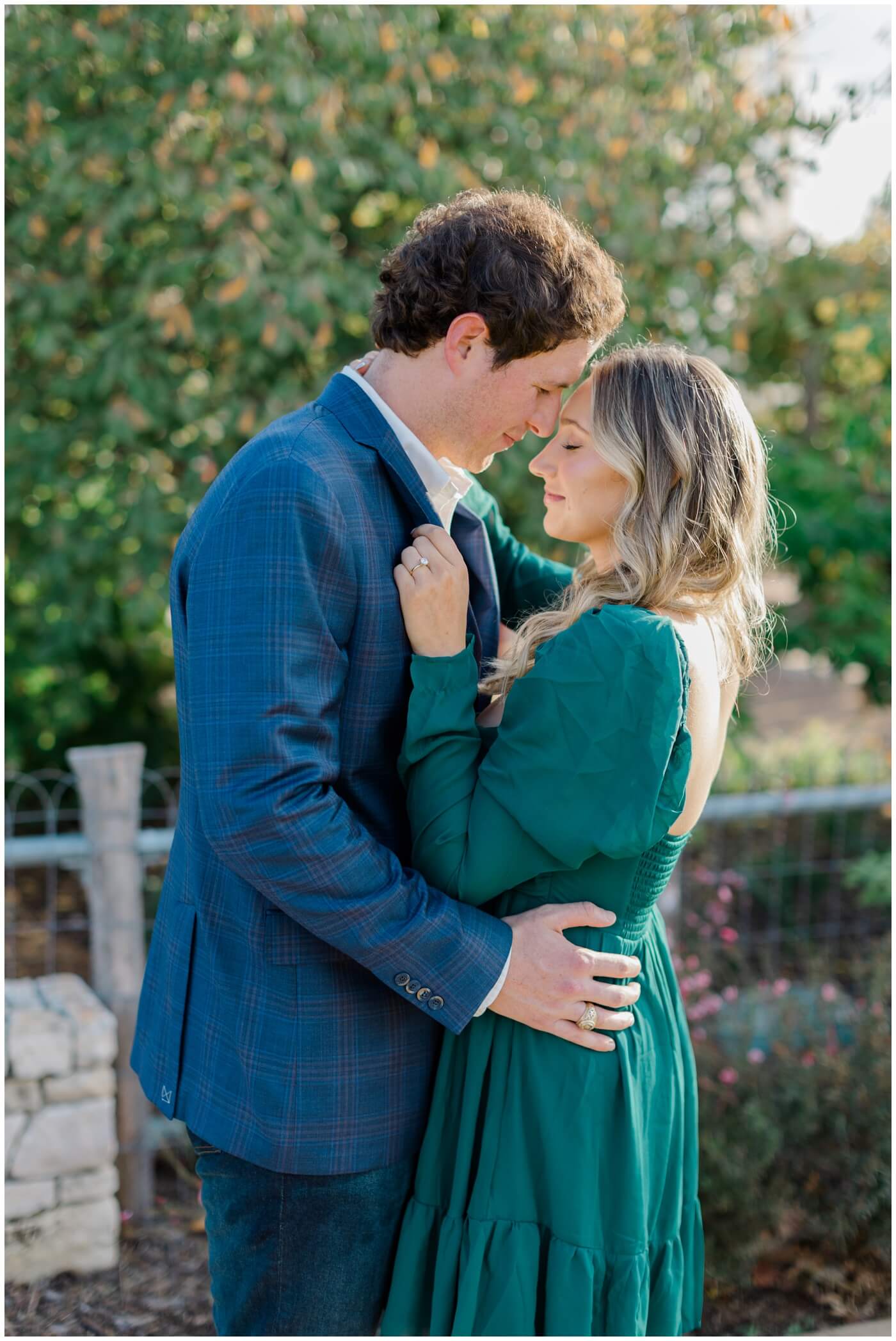 A couple snuggles close during their houston engagement session