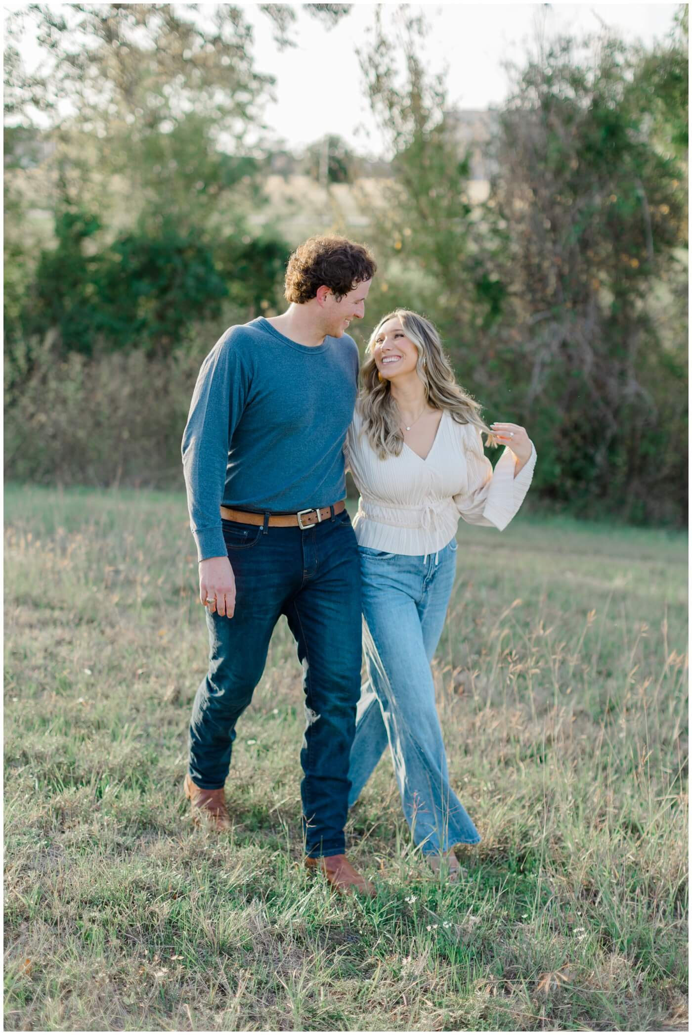 A couple walk together during their engagement session in Houston
