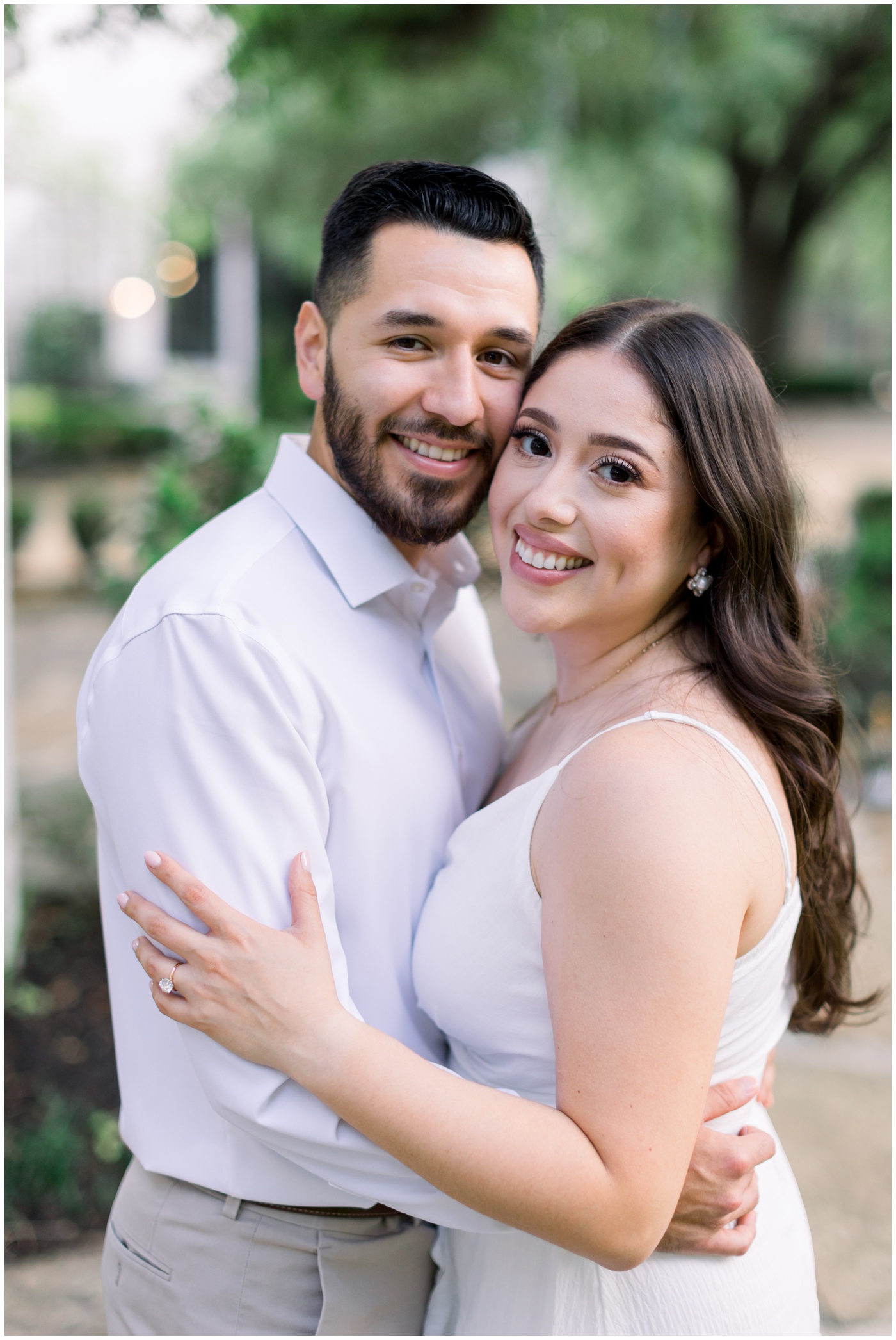 A couple smiles together during their Houston engagement session at the Peach Orchard Venue